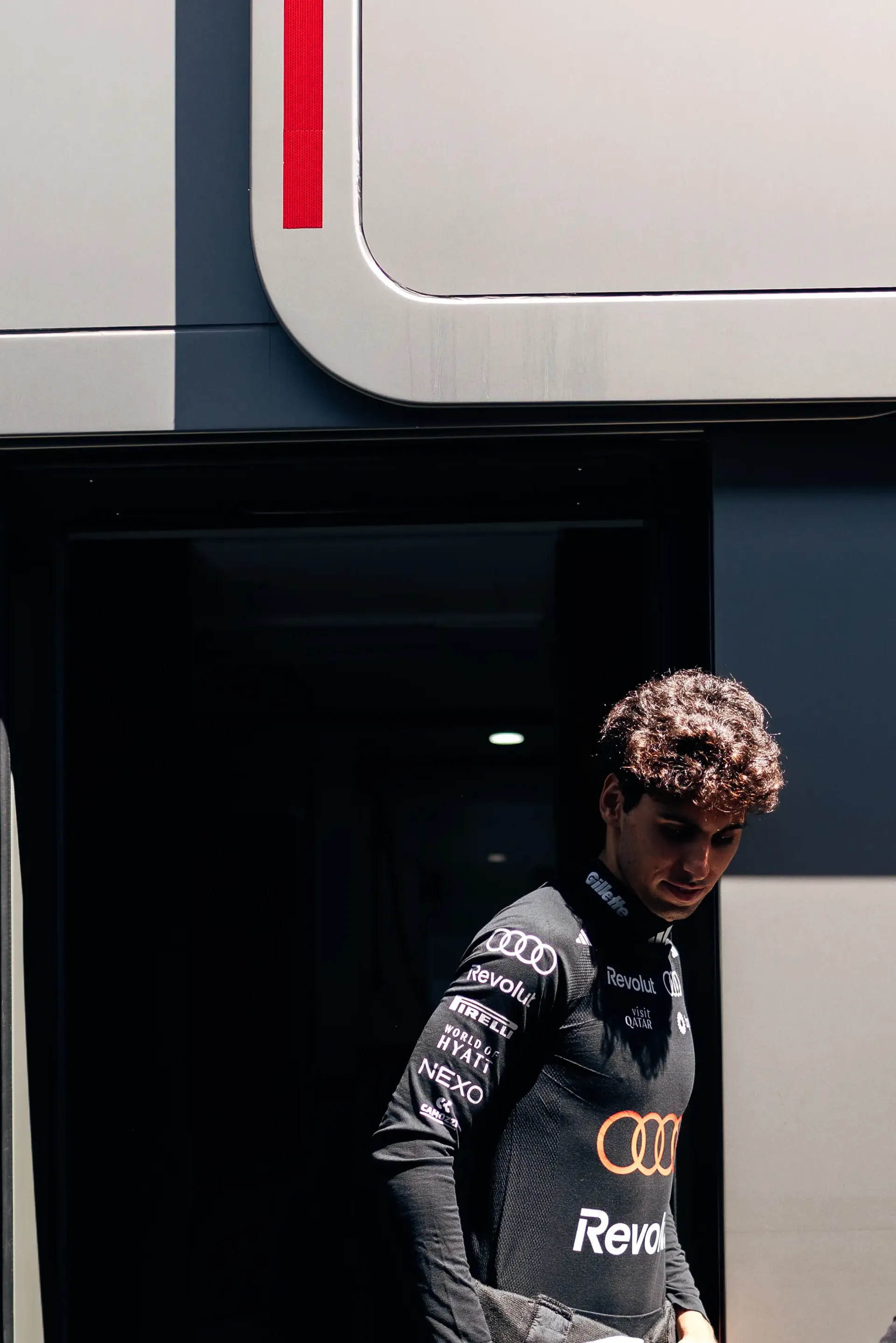 Audi Revolut F1® Team driver Gabriel Bortoleto walks outside the Audi Revolut F1® Team hospitality unit before FP3 at the Hungaroring.