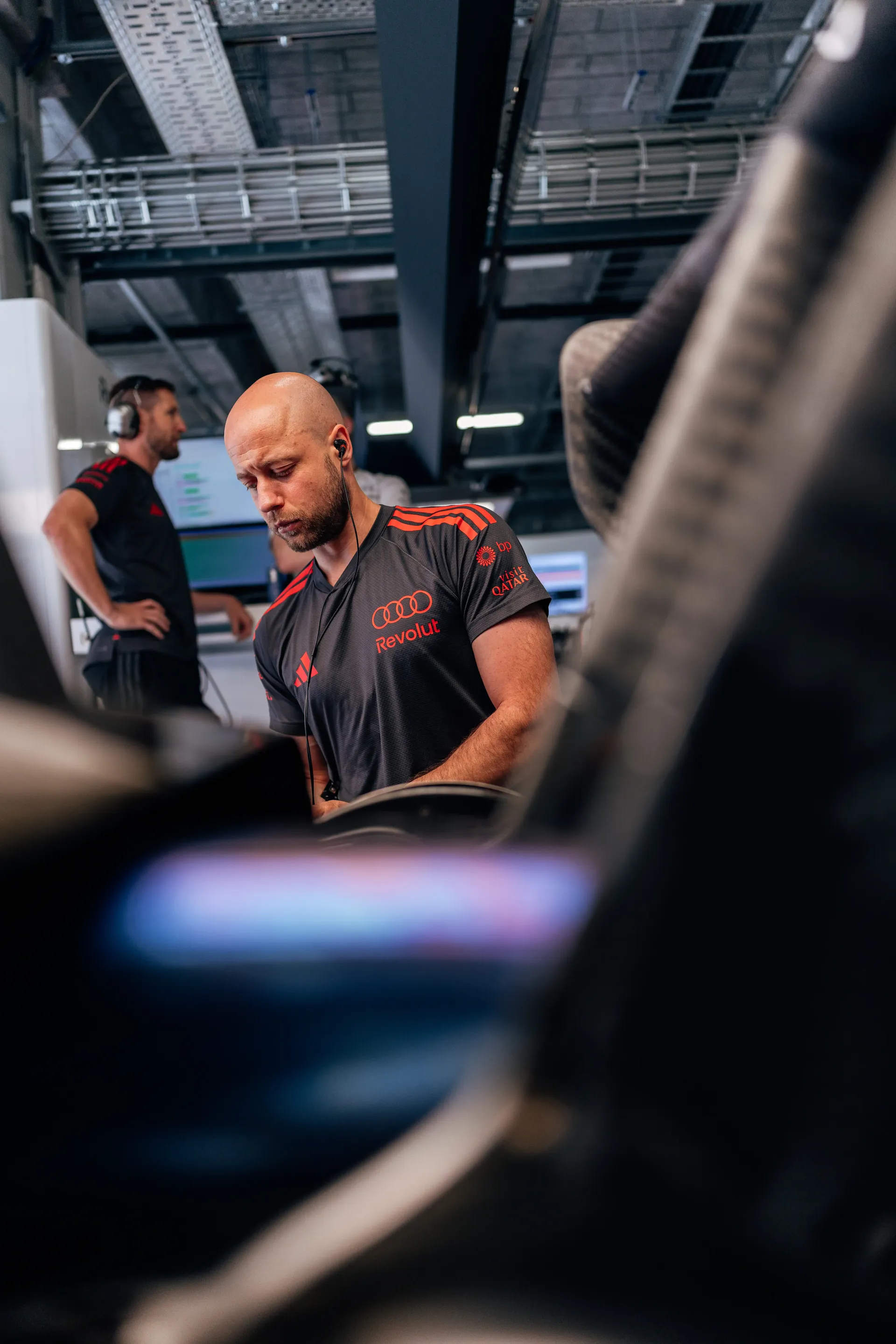 An Audi Revolut F1® Team mechanic works inside the Audi Revolut F1® Team garage during preparations for FP3 at the Hungaroring.
