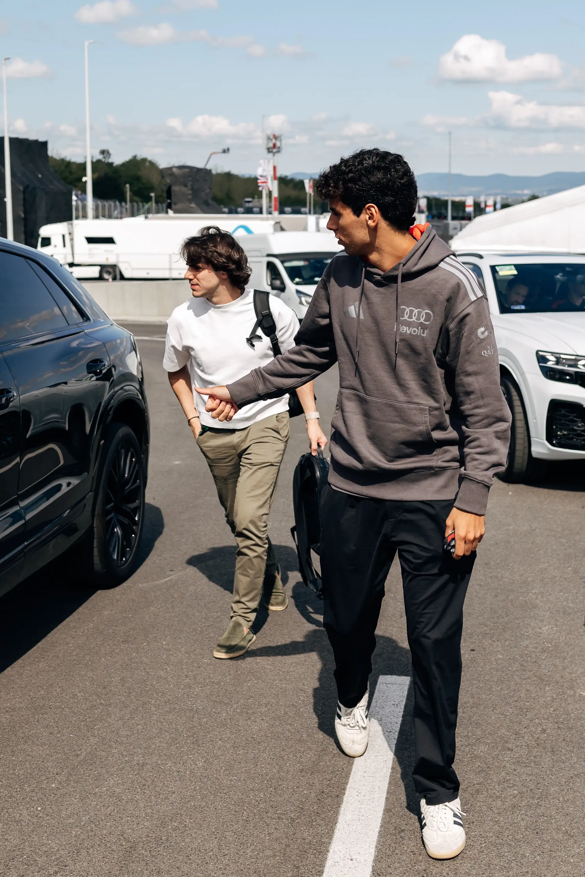 Audi Revolut F1® Team driver Gabriel Bortoleto steps out of a team car on arrival at the Hungaroring ahead of FP1 at the Hungarian Grand Prix.