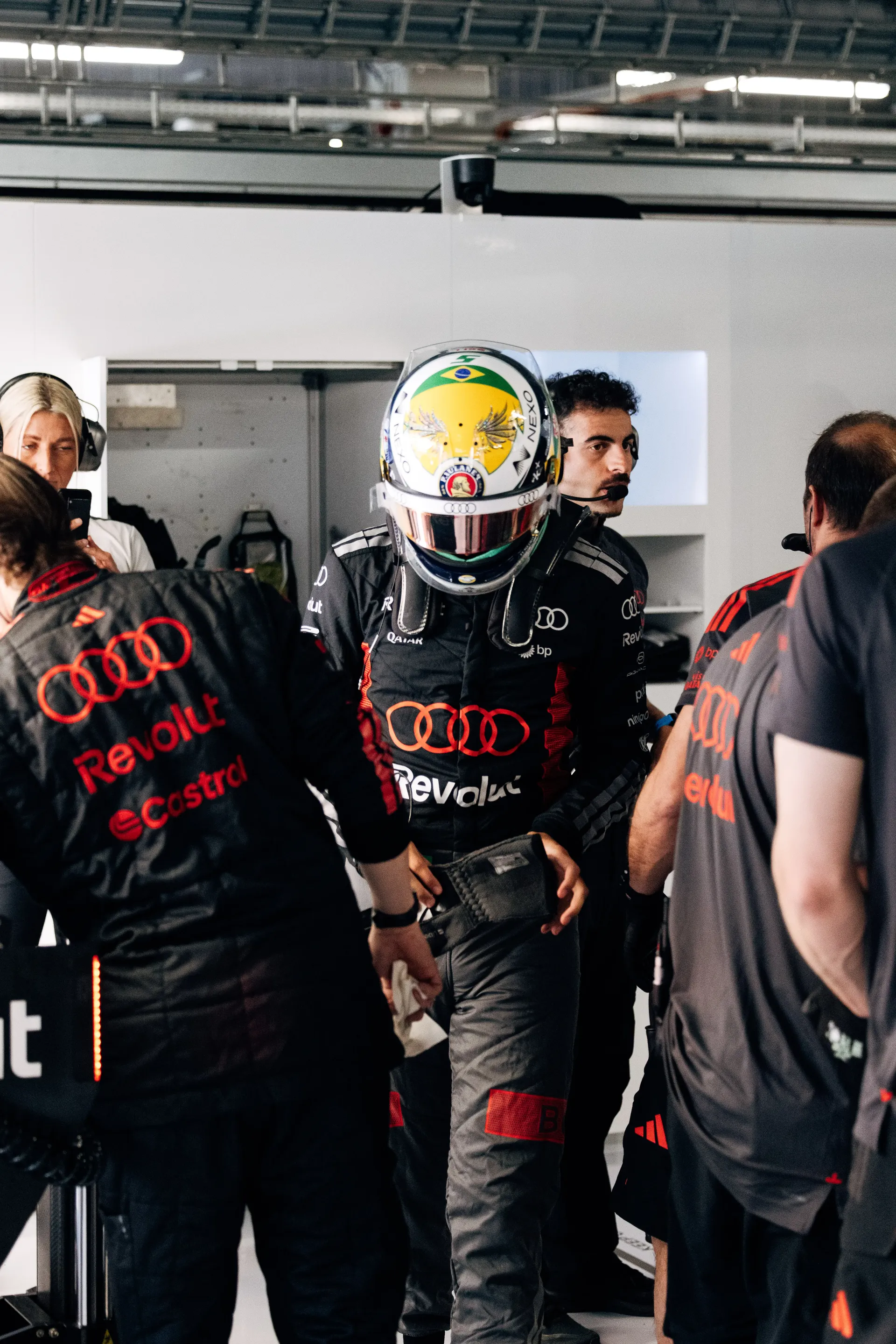 Audi Revolut F1® Team mechanics gather in the garage during FP1 preparations.