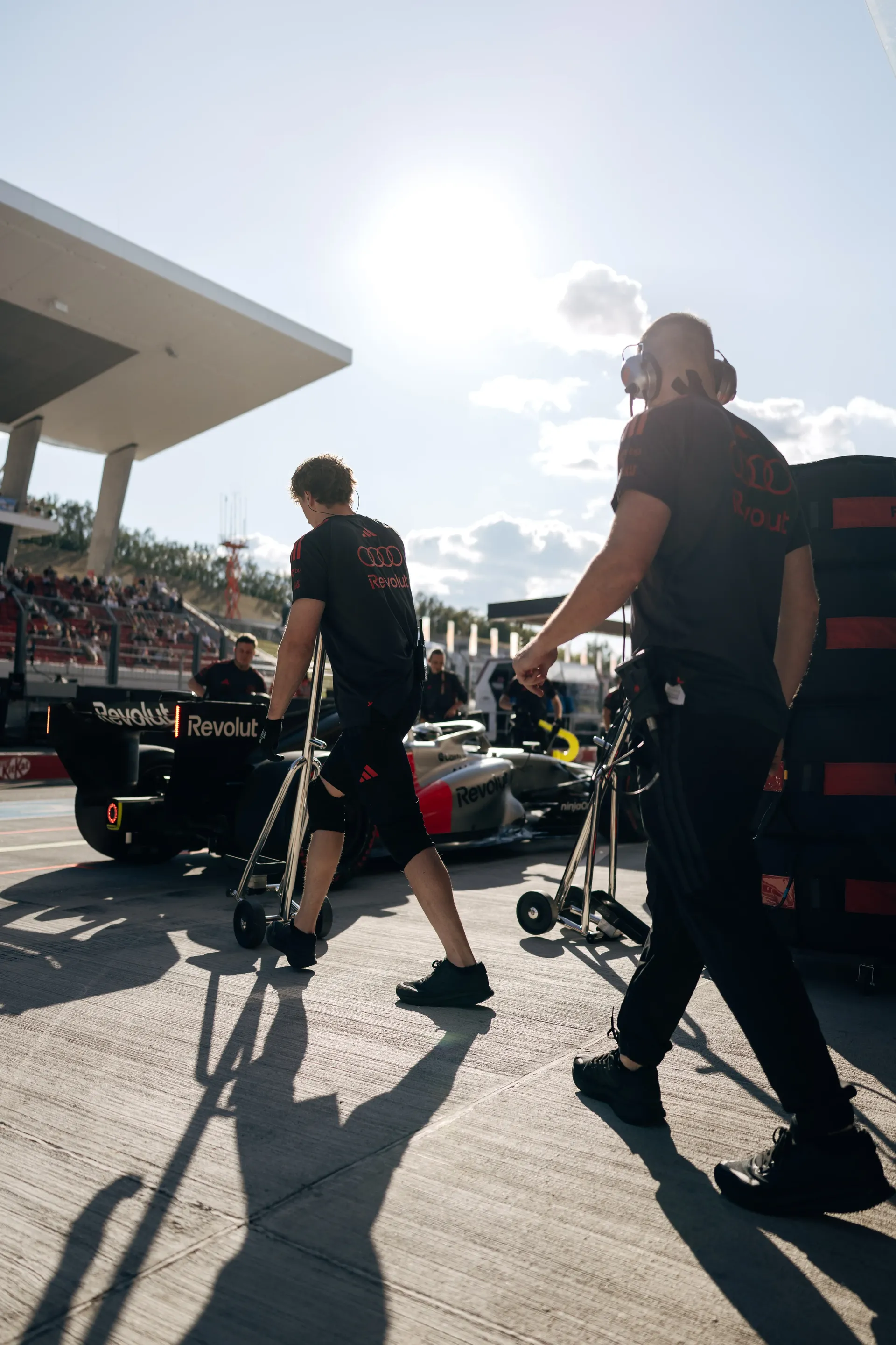 Audi Revolut F1® Team mechanics prepare equipment in the pit lane before FP2 at the Hungaroring.