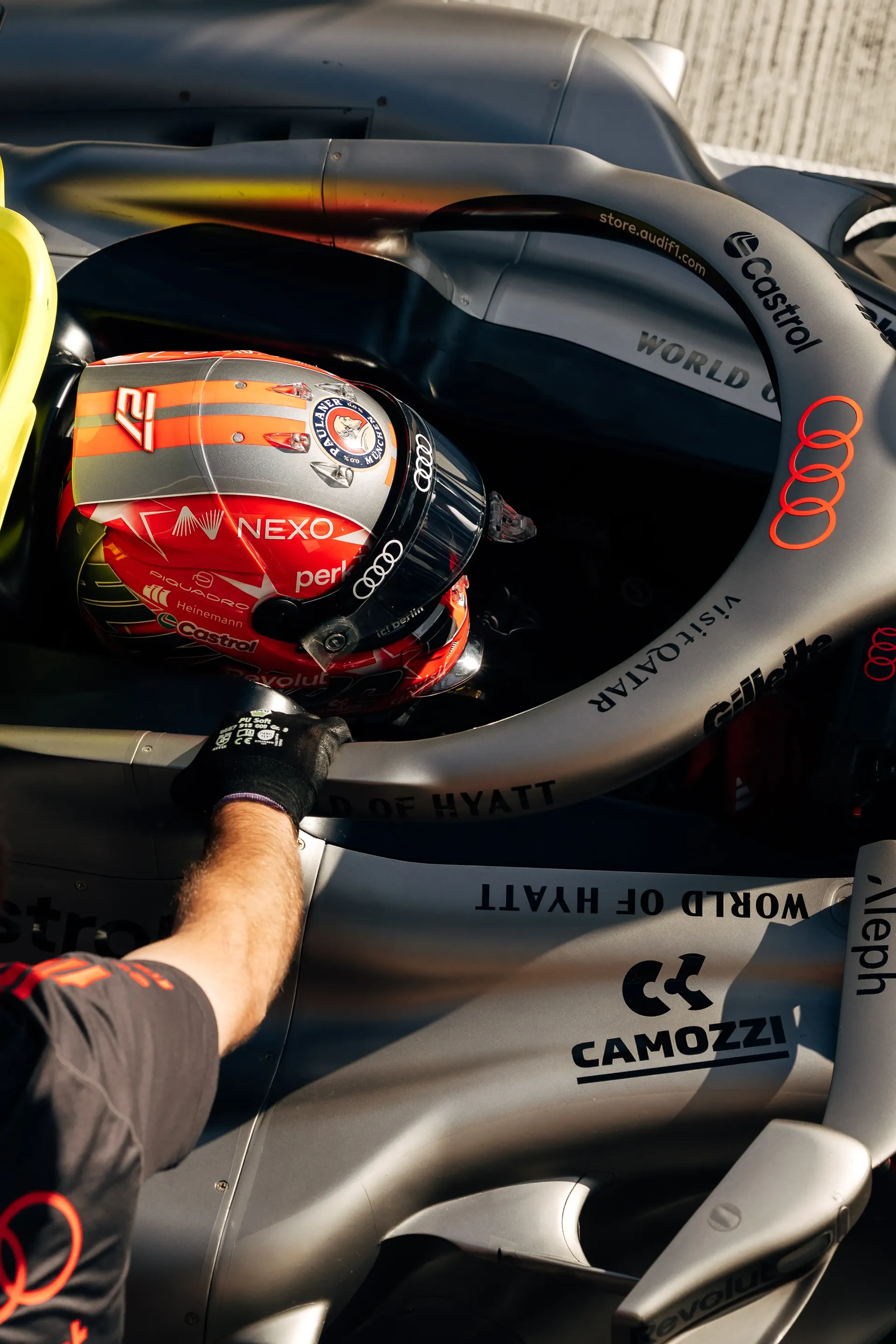 Audi Revolut F1® Team driver Nico Hulkenberg sits in the cockpit of the Audi Revolut F1® Team car Audi R26 wearing his new red helmet during FP2.