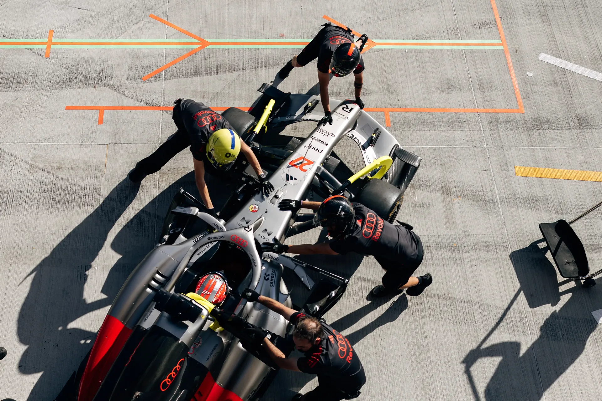 Overhead shot of Audi Revolut F1® Team mechanics surrounding the Audi Revolut F1® Team car Audi R26 in the pit lane during FP2.
