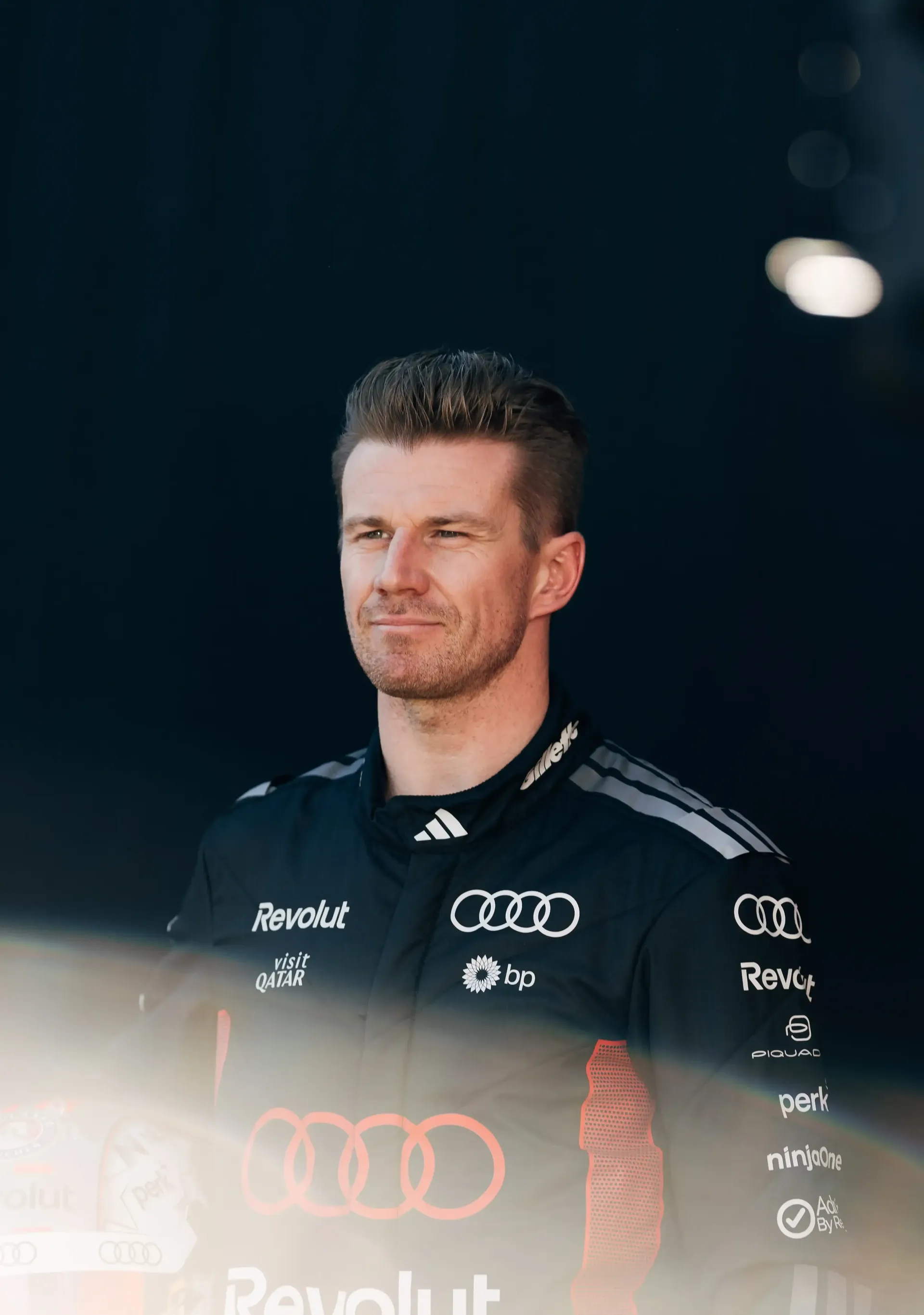 Audi Revolut F1® Team driver Nico Hulkenberg holding his helmet at the side of the racetrack