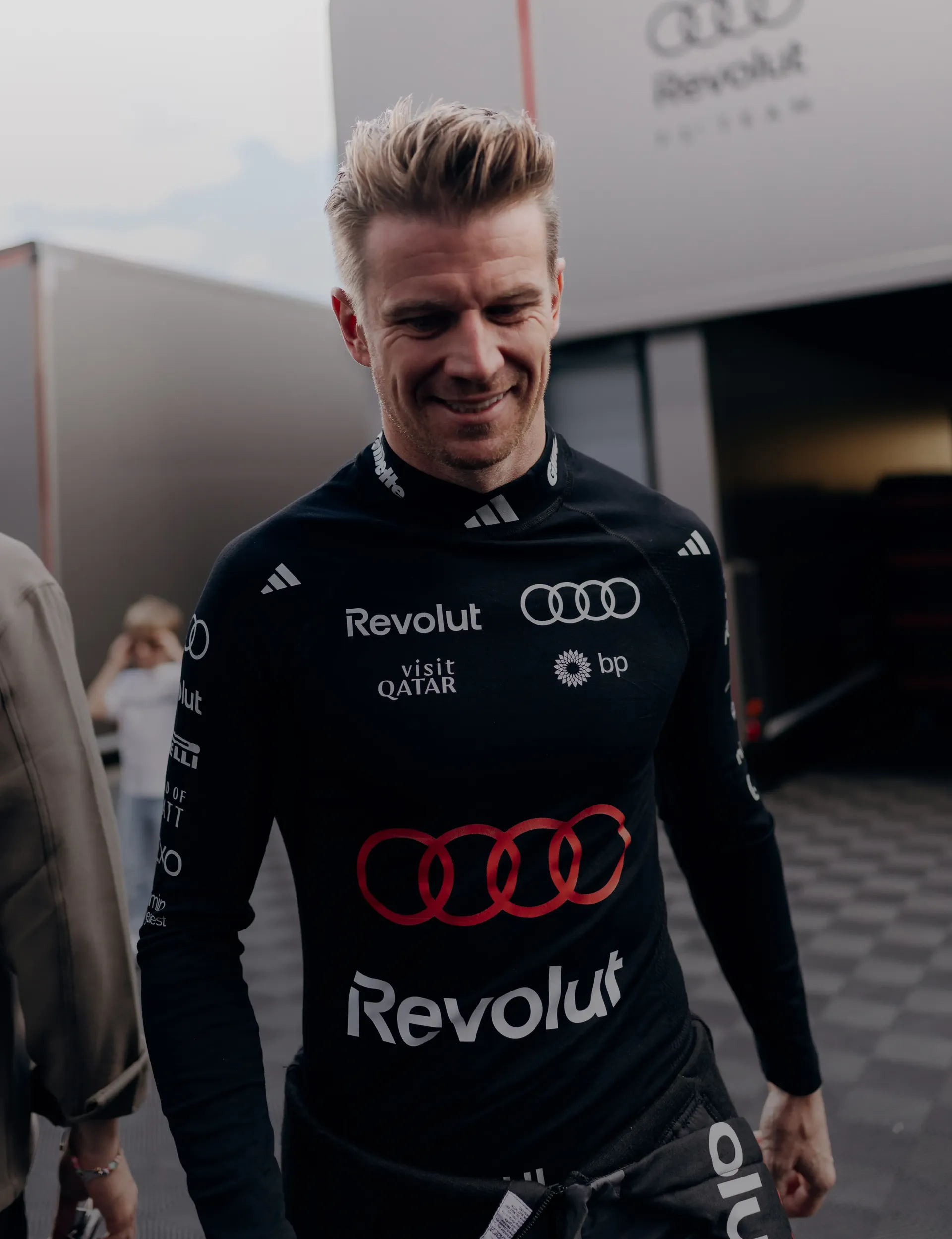 Audi Revolut F1® Team driver Nico Hulkenberg smiling in front of the garage at the Hungarian GP 2026 after FP2