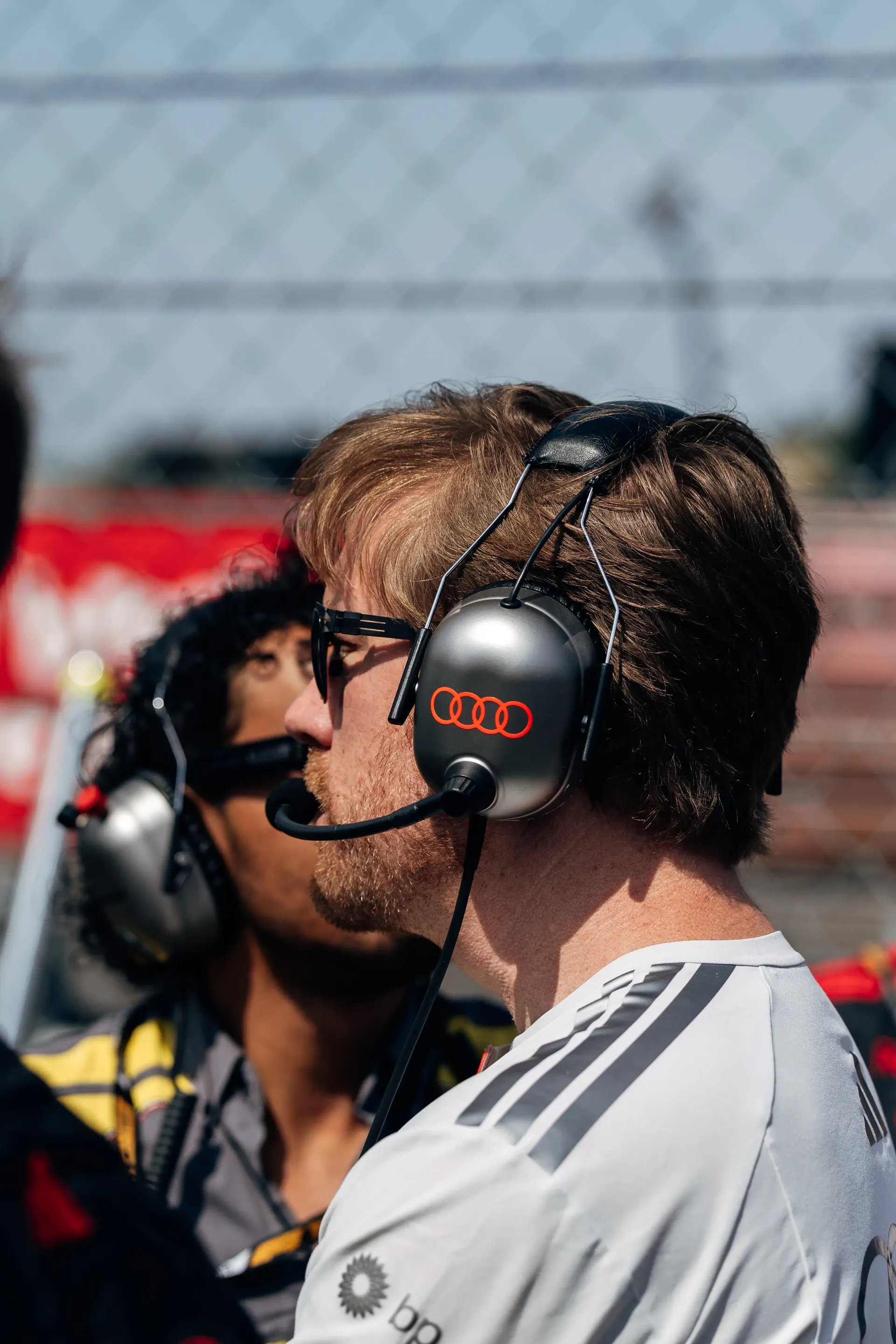Audi Revolut F1® Team engineers wearing headsets monitor preparations from the Hungaroring grid.