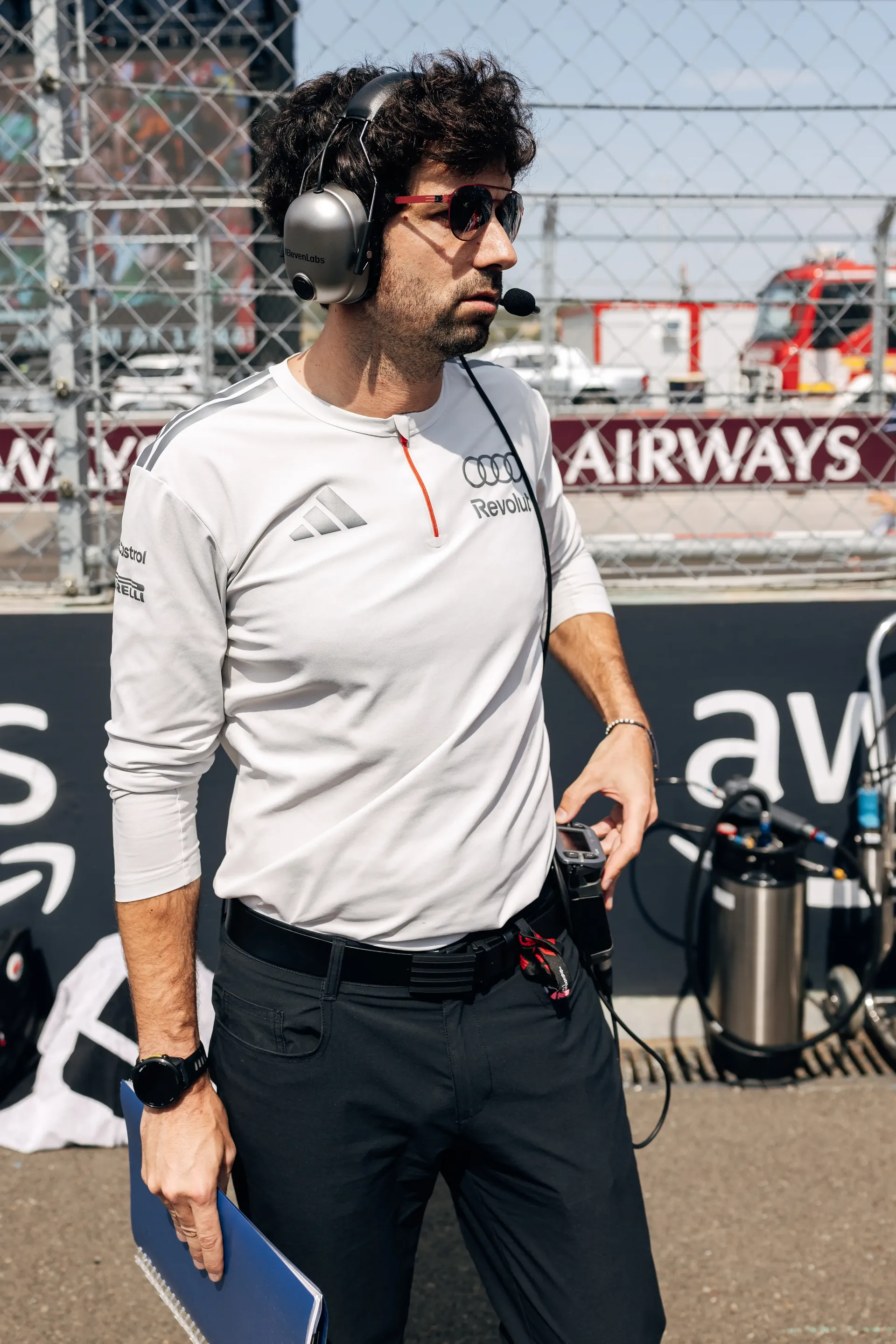 An Audi Revolut F1® Team engineer walks across the Hungaroring grid carrying equipment before the race.
