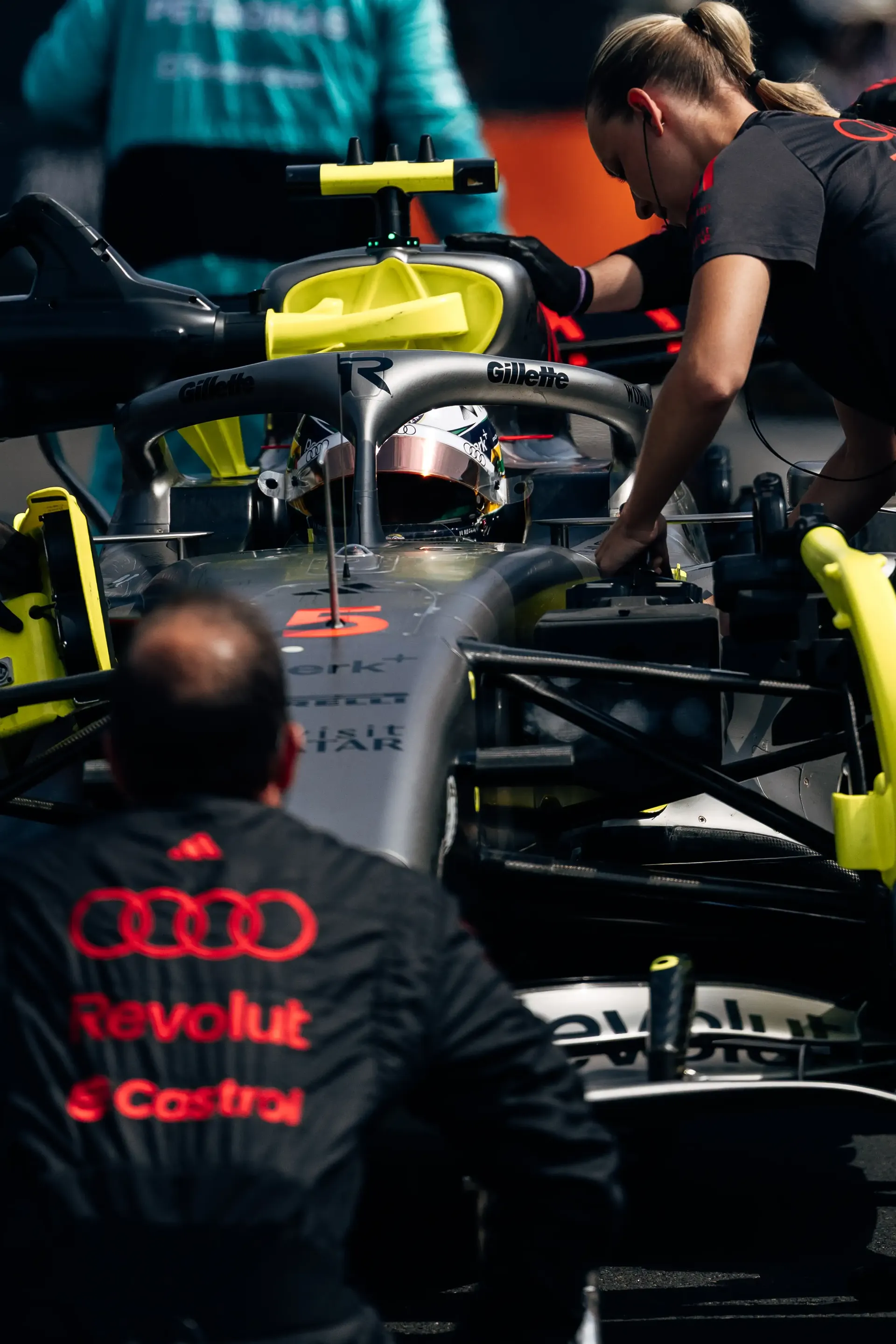 Audi Revolut F1® Team mechanics work on the Audi R26 during final pre-race checks in the Hungaroring pit lane.
