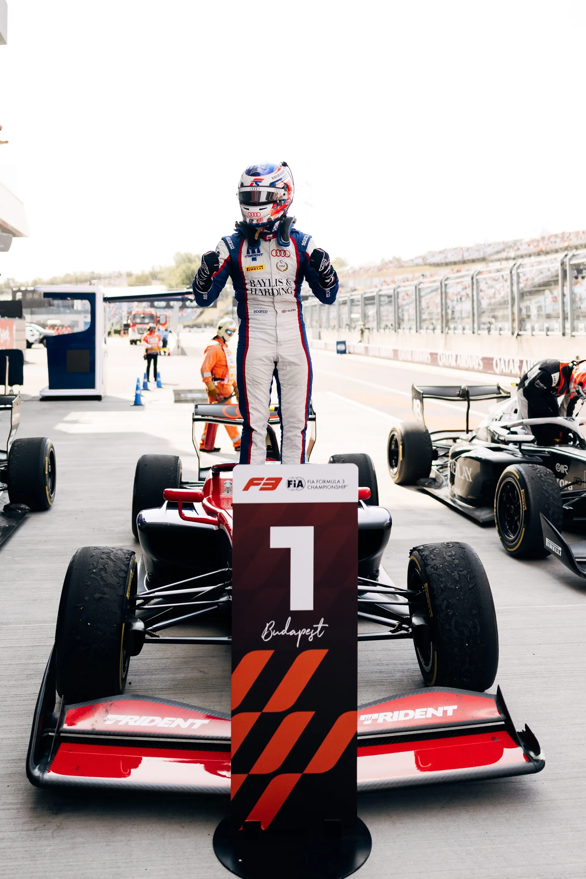 Freddie Slater standing on his Formula 3 car behind the number 1 board in Budapest