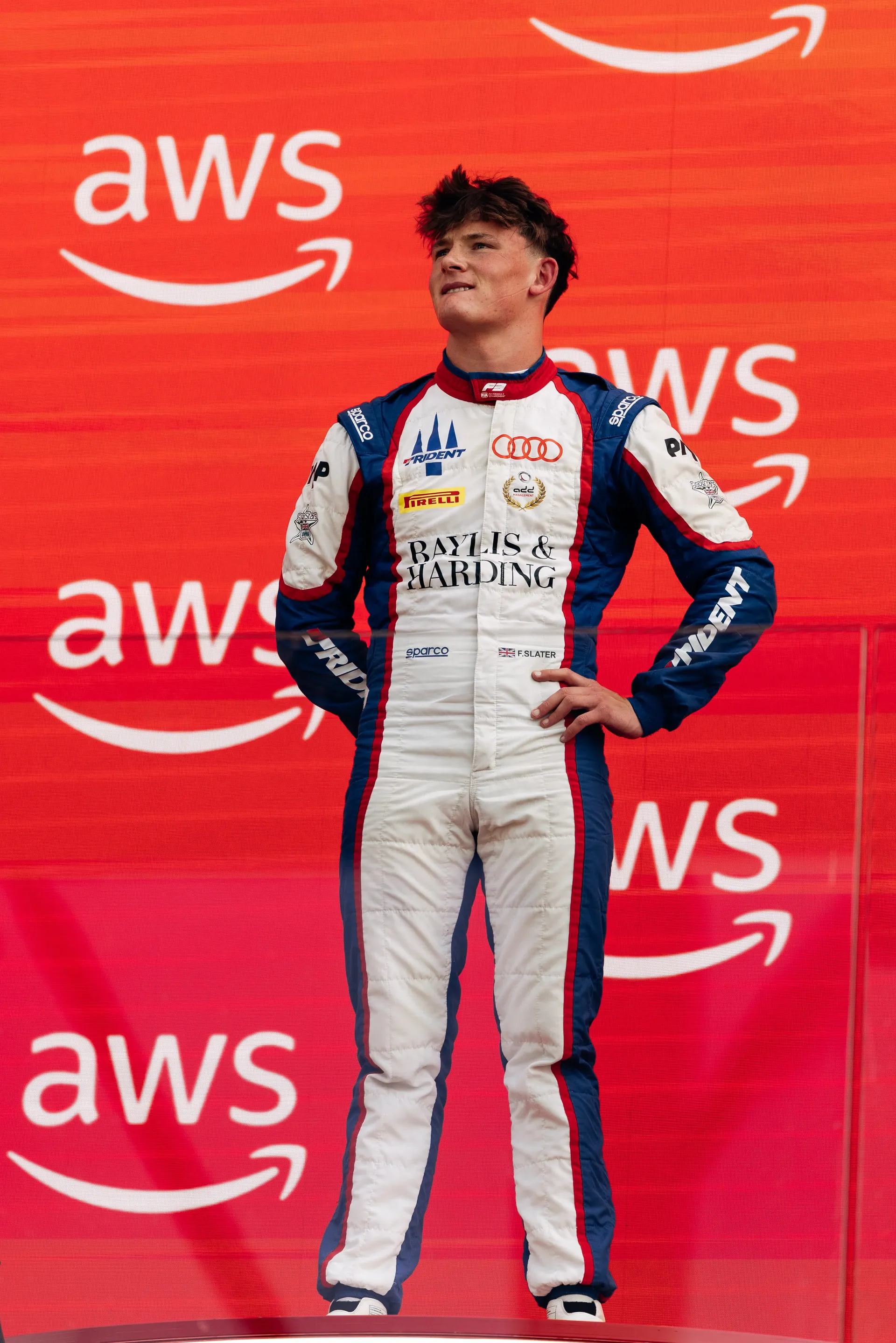 Freddie Slater standing on the podium in his race suit in Budapest
