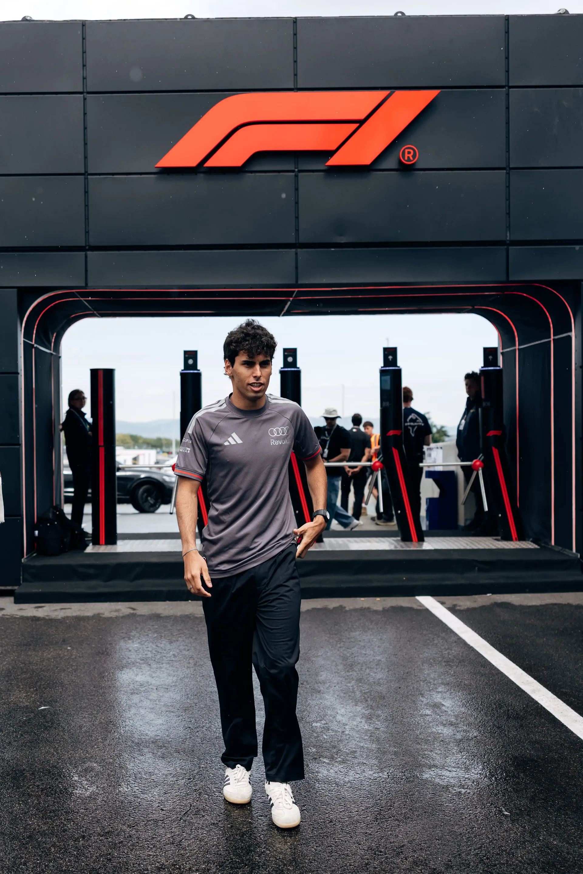 Audi Revolut F1® Team driver Gabriel Bortoleto walks through the Formula 1® paddock at the Hungaroring on Thursday.