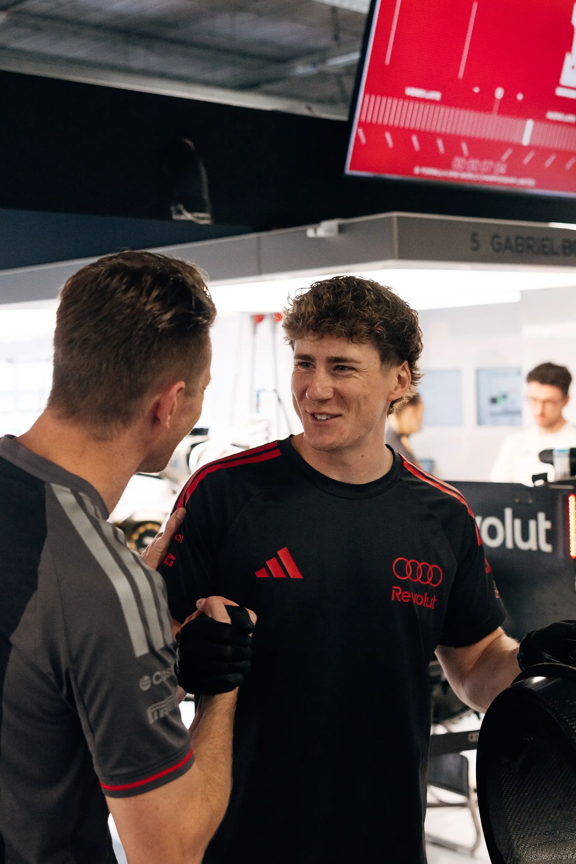 Audi Revolut F1® Team driver Nico Hulkenberg chats with a team member in the Hungaroring garage.