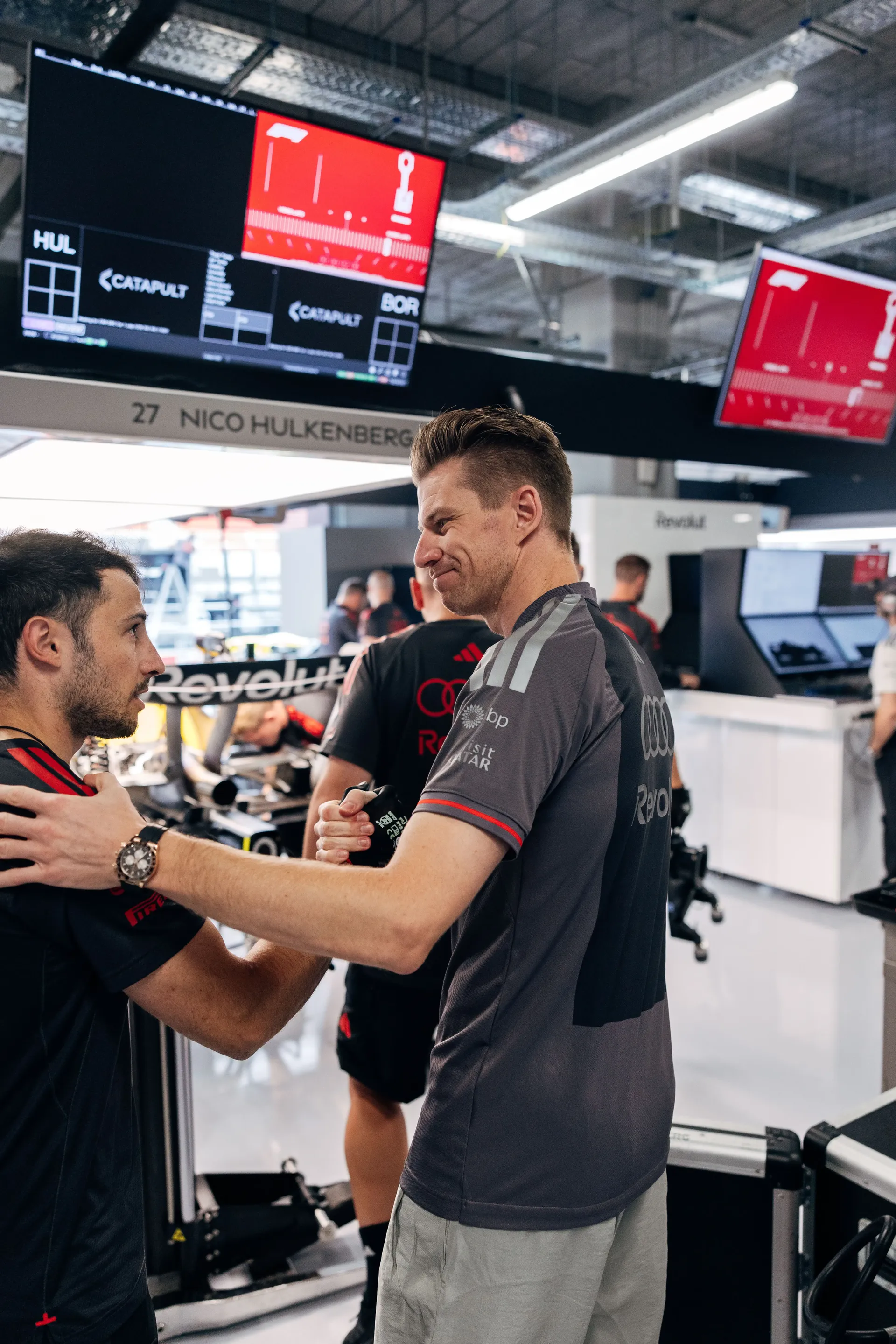 Audi Revolut F1® Team driver Nico Hulkenberg greets a team member in the Hungaroring garage.