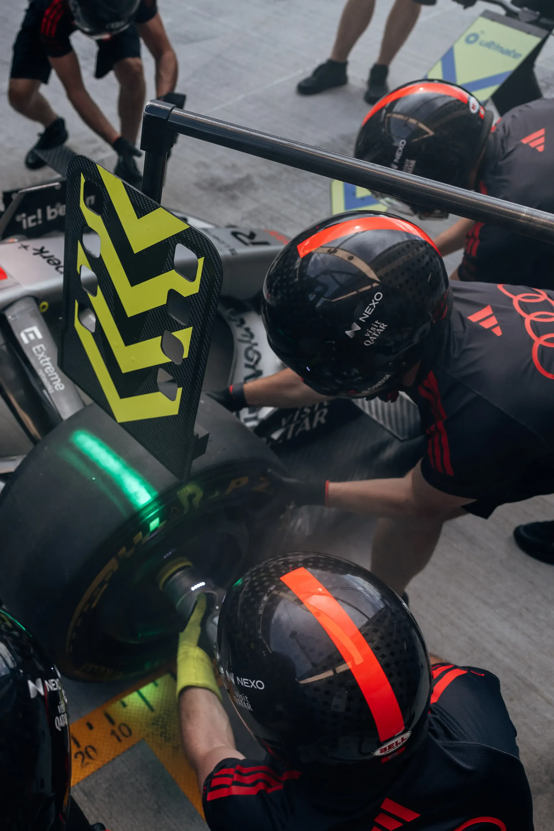 Audi Revolut F1® Team pit crew work on the Audi R26 during driver installation ahead of FP1 at the Hungaroring.