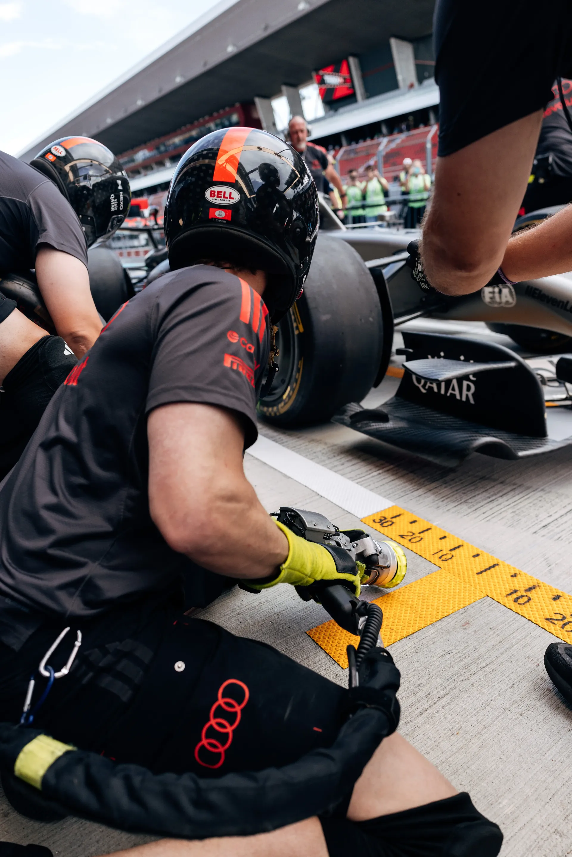 Audi Revolut F1® Team mechanic works on the Audi R26 during driver installation ahead of FP1 at the Hungaroring.
