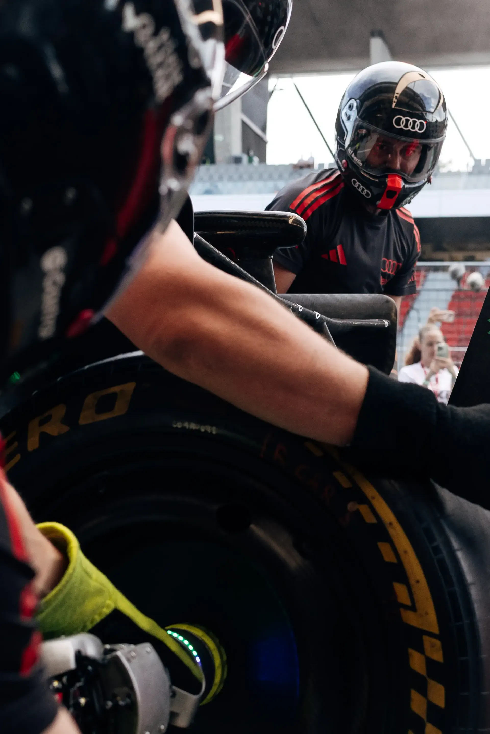 Audi Revolut F1® Team mechanic works on the Audi R26 during driver installation ahead of FP1 at the Hungaroring.