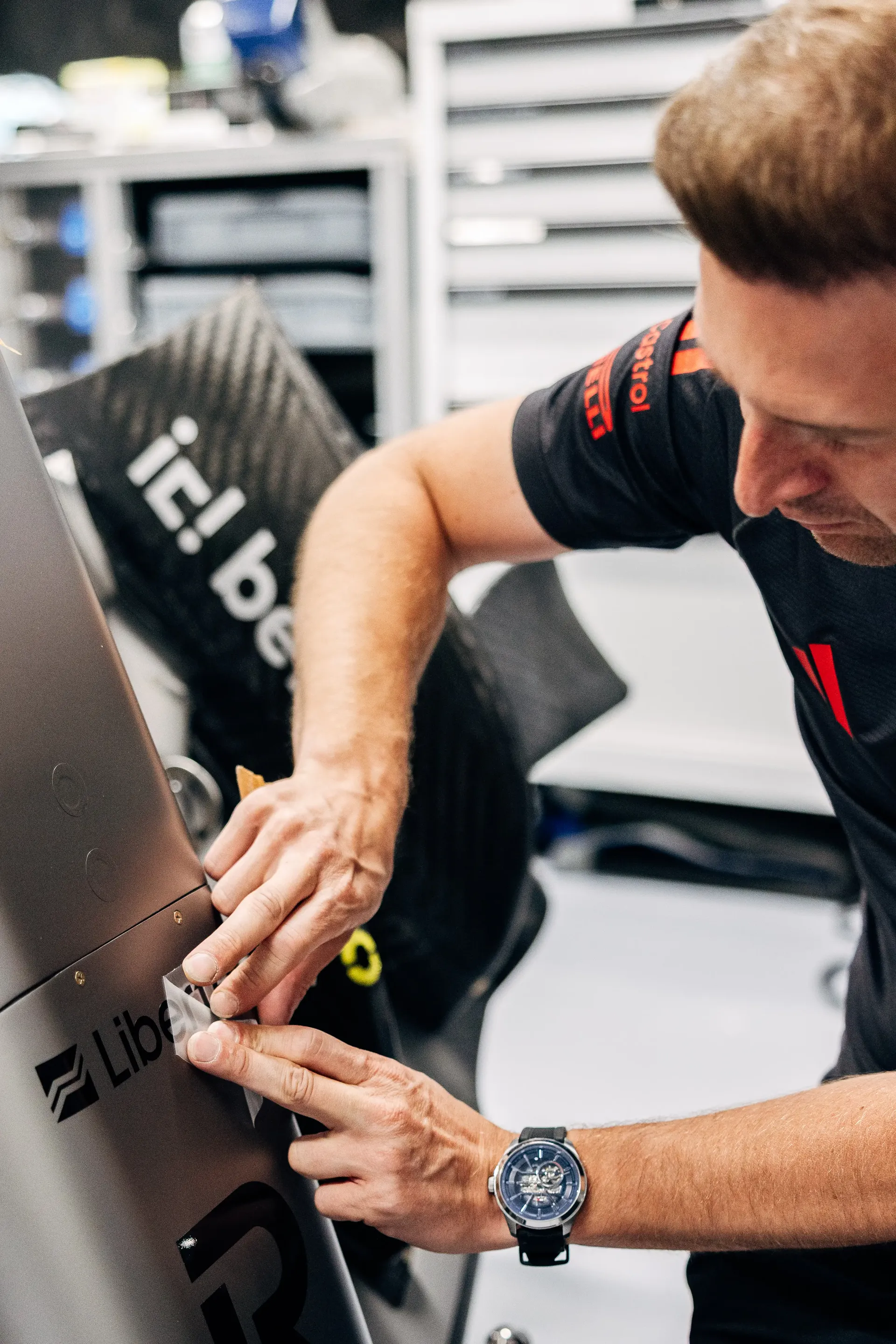 Audi Revolut F1® Team mechanic works on the side of the Audi R26 during Thursday preparations.