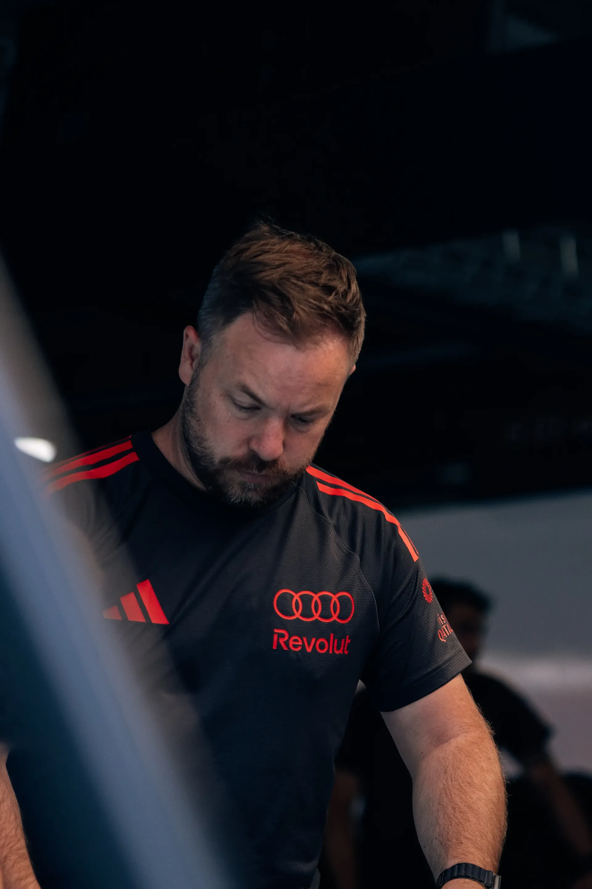 Audi Revolut F1® Team mechanic walks through the garage during Thursday preparations.