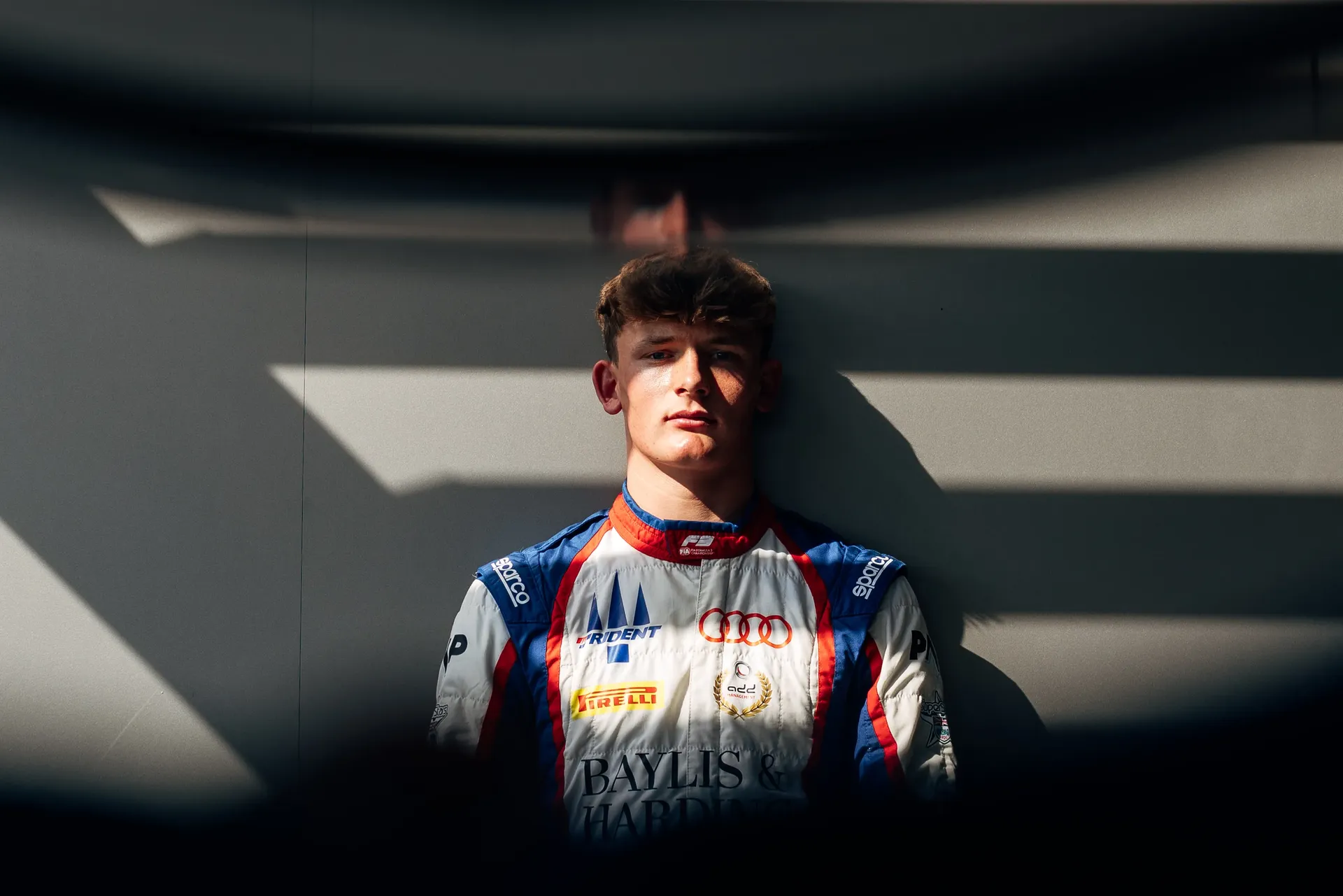 Portrait of Audi Revolut F1® Team F3 driver Freddie Slater in complete team gear in the studio at the Italian GP
