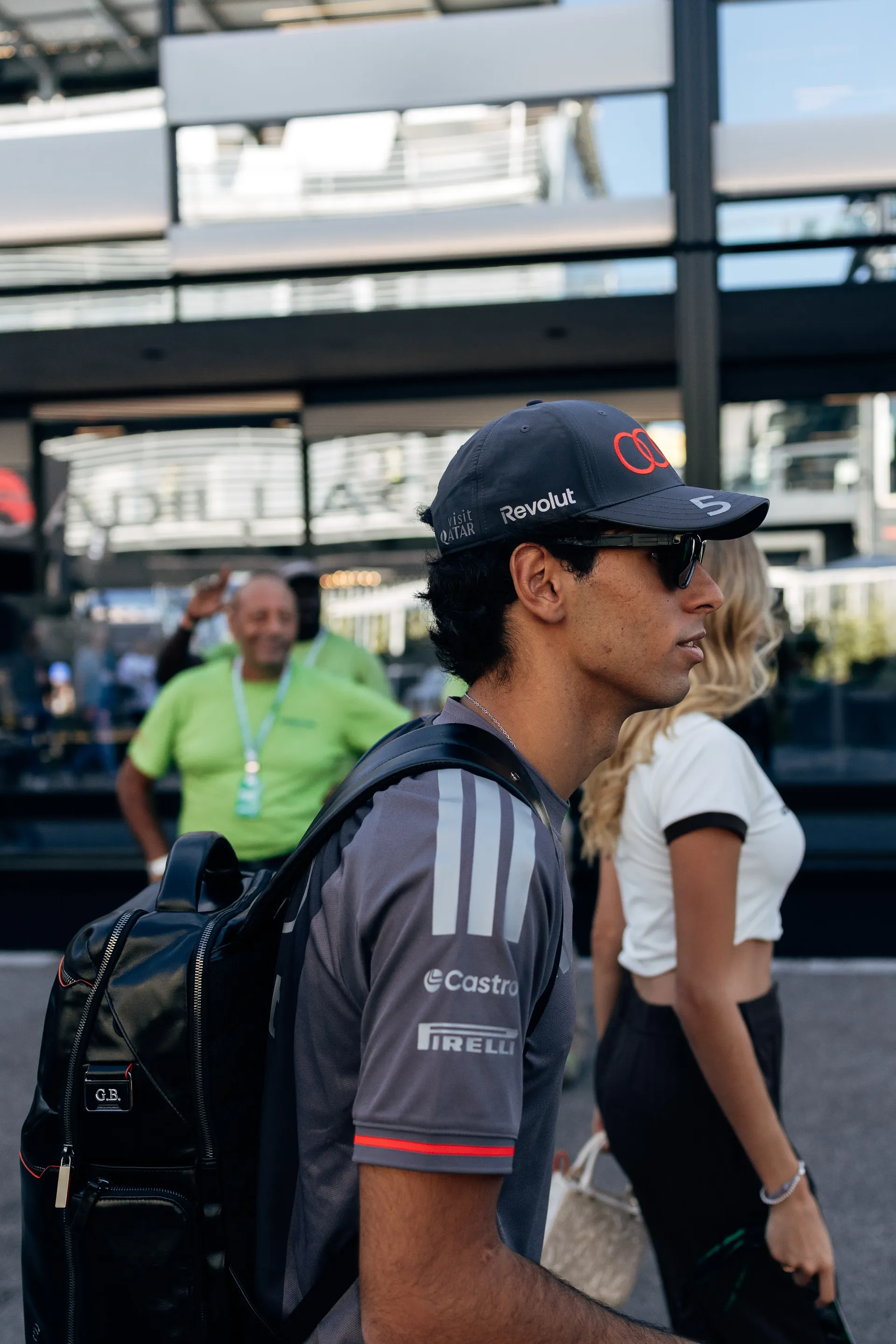 Audi Revolut F1® Team driver Gabriel Bortoleto walking through the Monza paddock with a backpack
