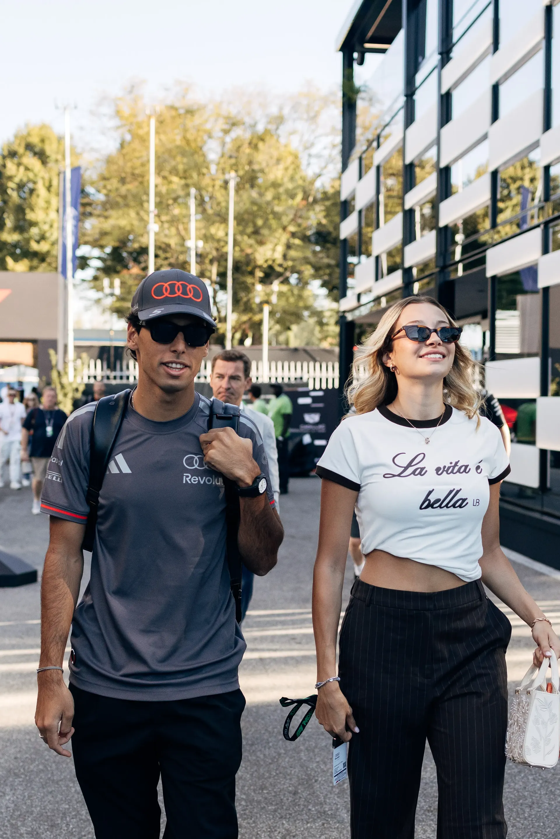 Audi Revolut F1® Team driver Gabriel Bortoleto walking through the Monza paddock with his girlfriend