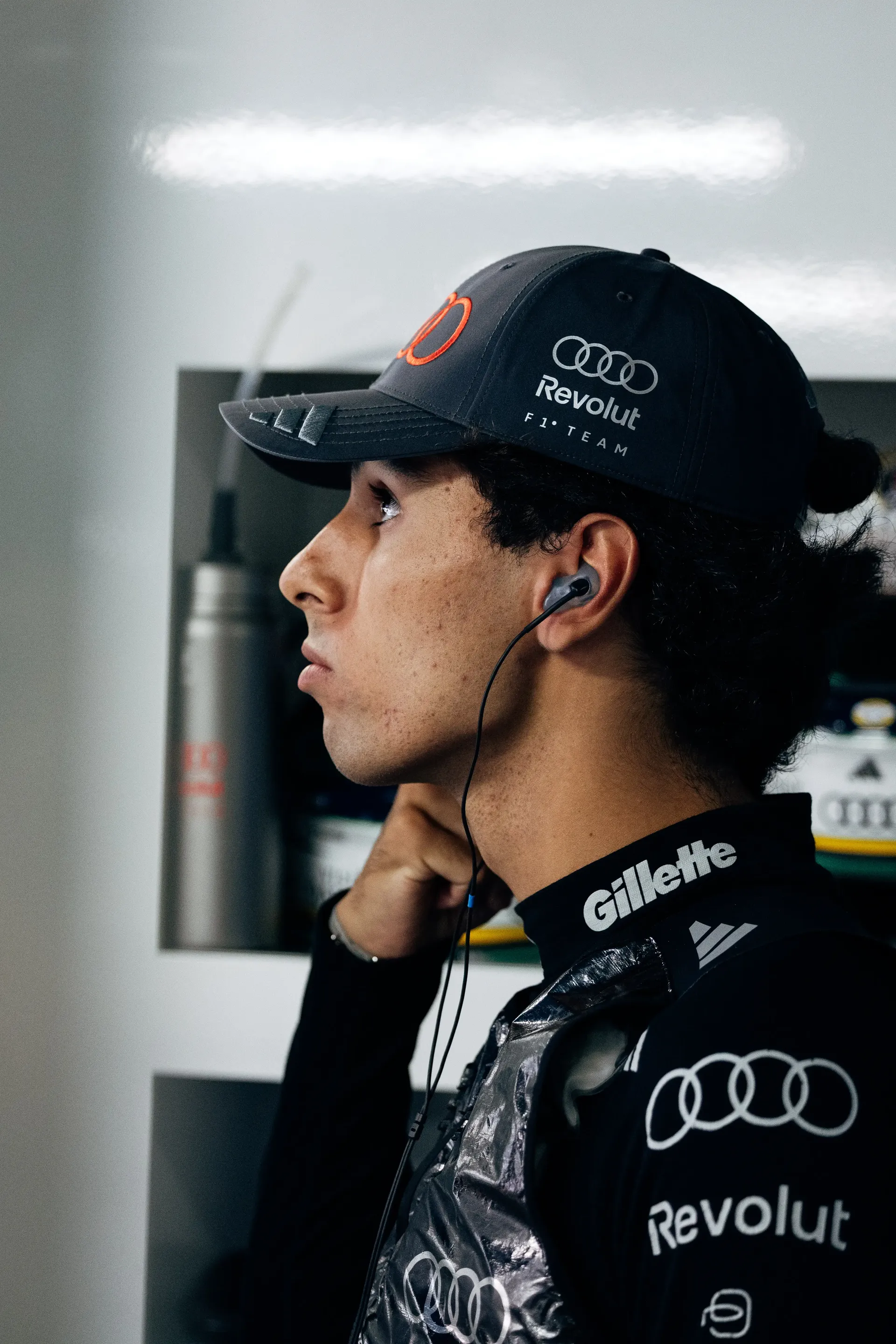 Audi Revolut F1® Team driver Gabriel Bortoleto in profile wearing team race gear