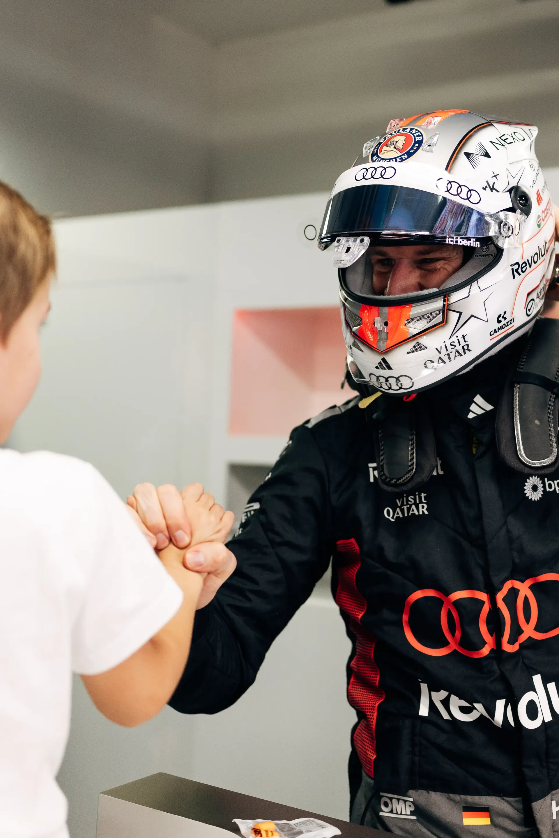 Audi Revolut F1® Team driver Nico Hulkenberg shaking hands with a team engineer