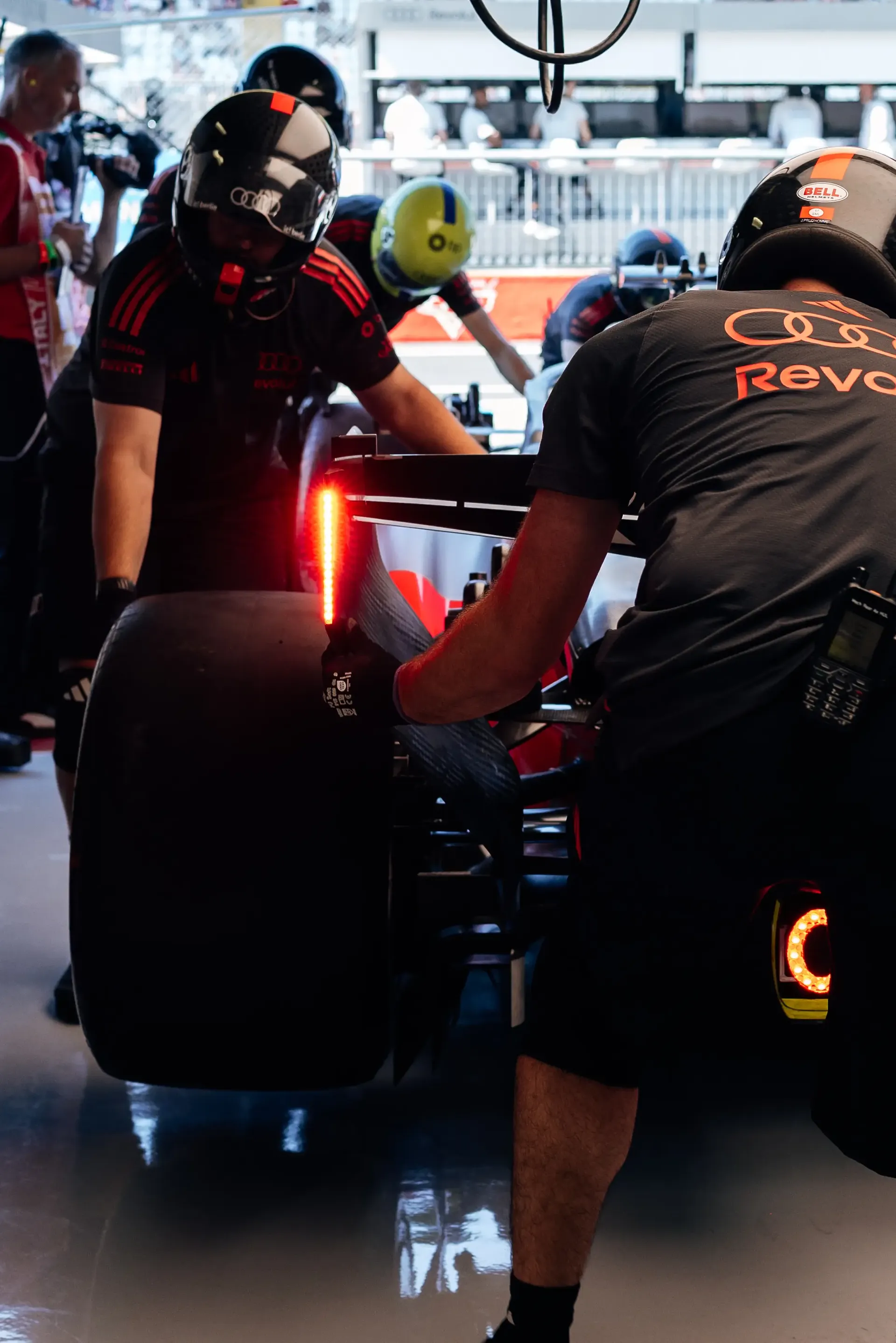 Audi Revolut F1® Team mechanics working on a rear tyre