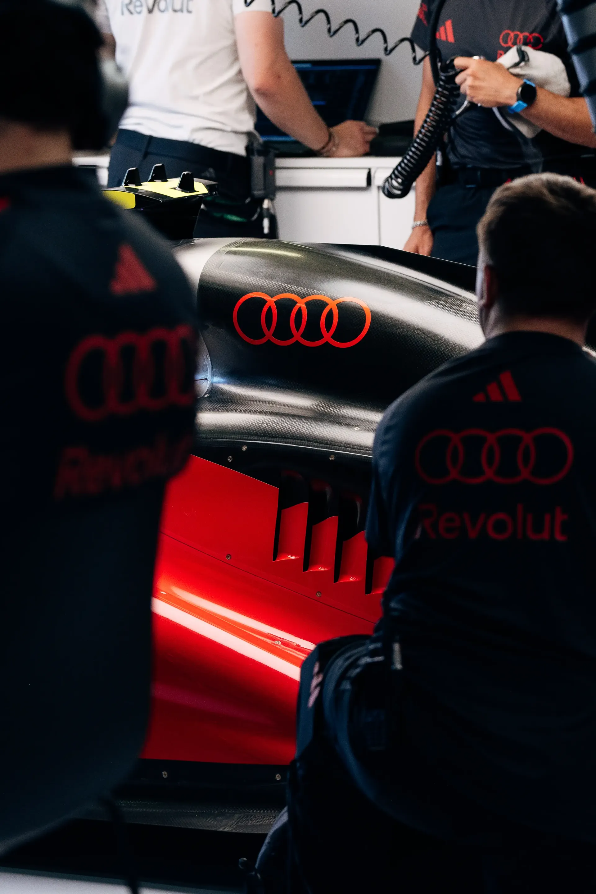 Audi Revolut F1® Team mechanics working around the Audi R26