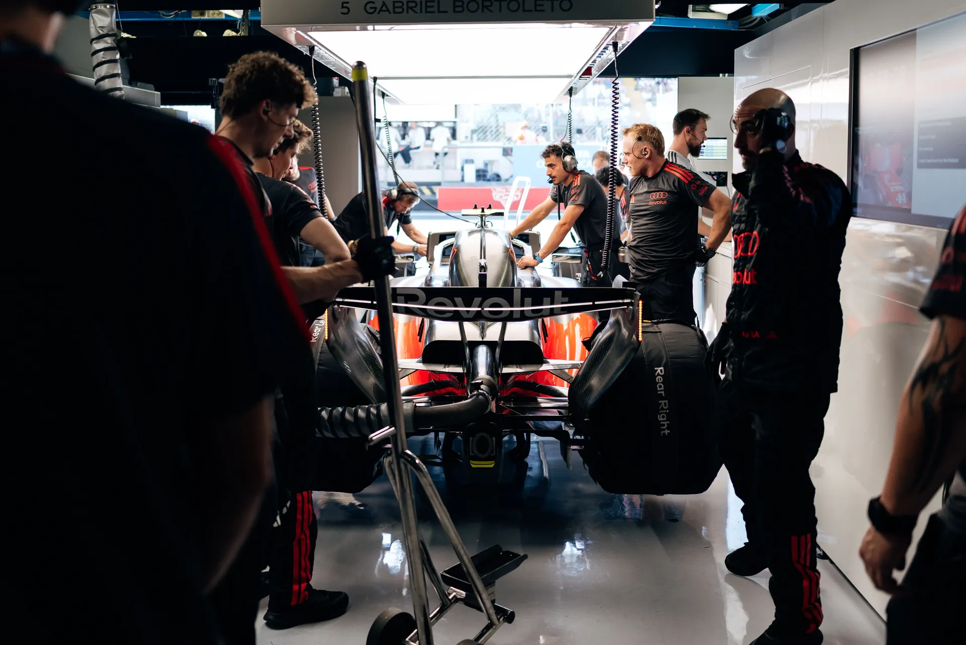 Audi Revolut F1® Team mechanics preparing the Audi R26 in the garage