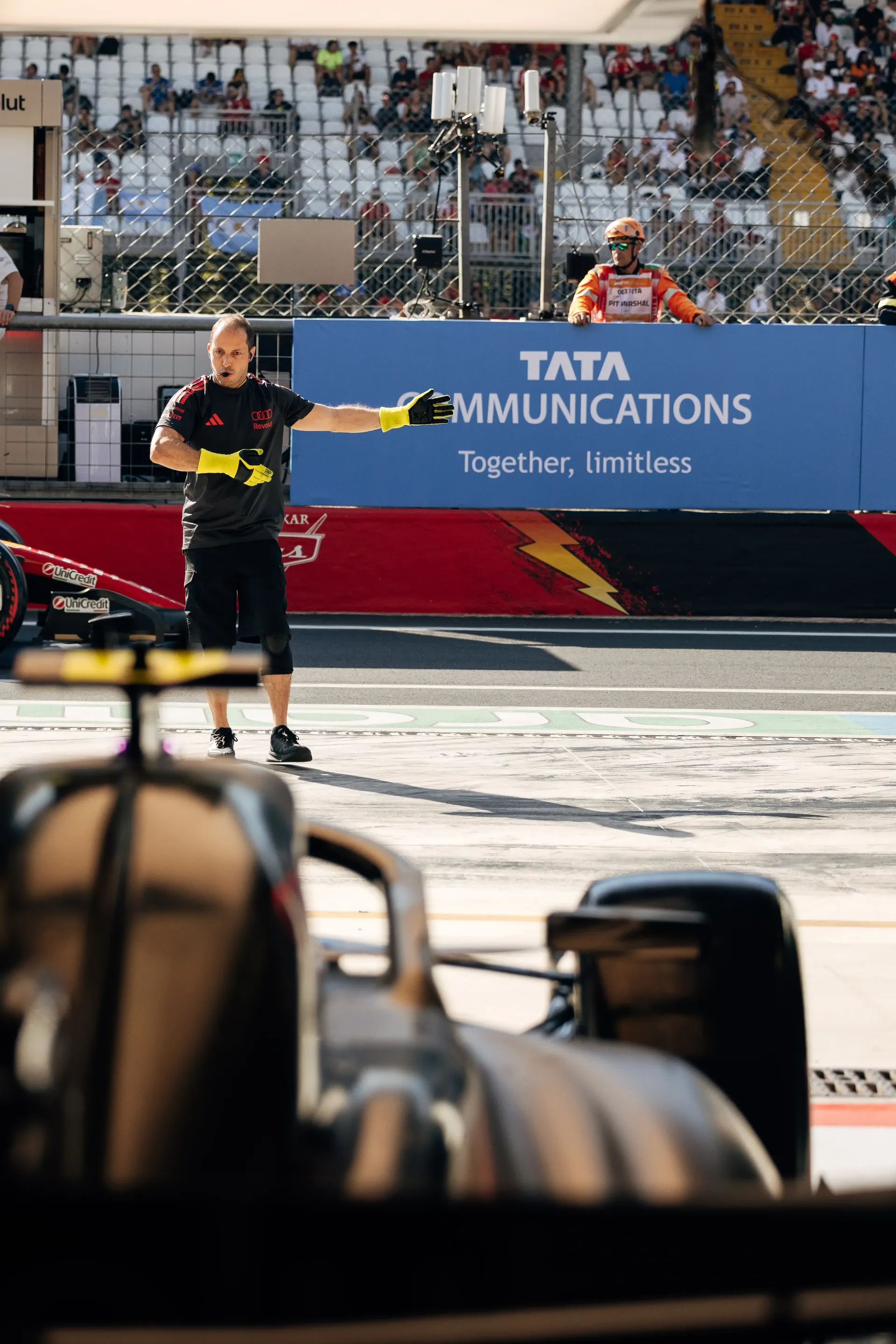 Audi Revolut F1® Team mechanic working at the garage pit wall