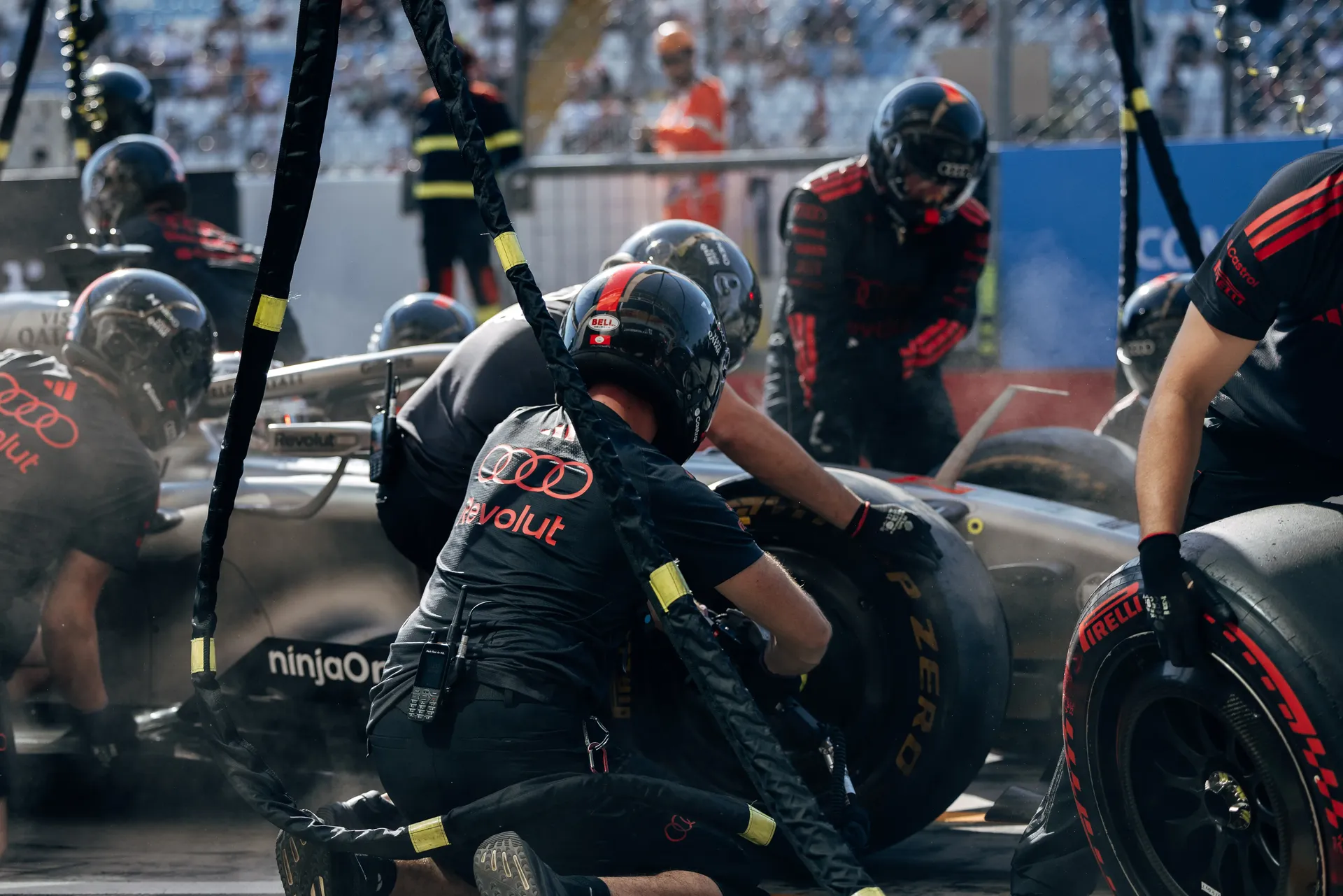 Audi Revolut F1® Team mechanics performing a pit stop on the Audi