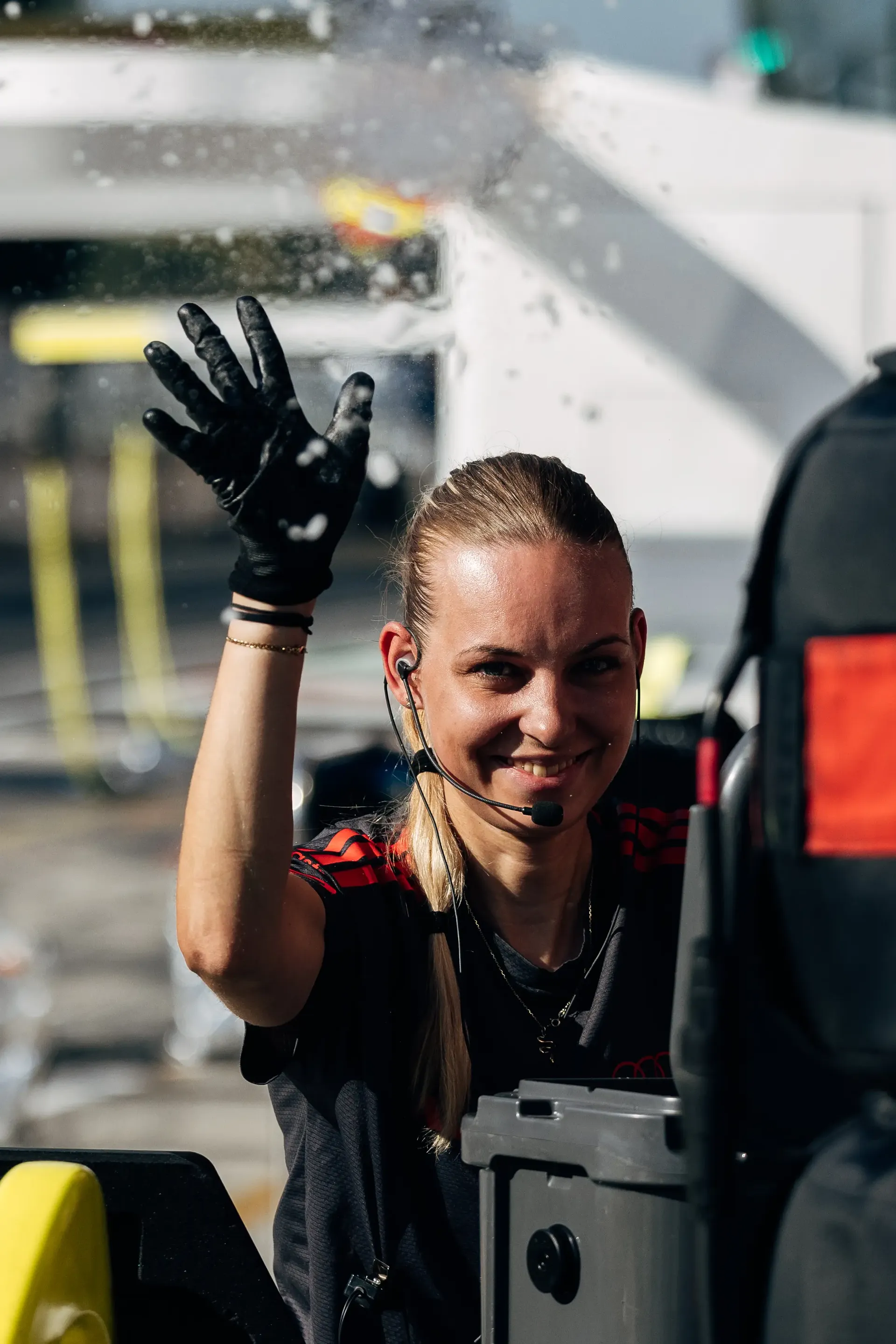 Audi Revolut F1® Team crew member waving from the garage