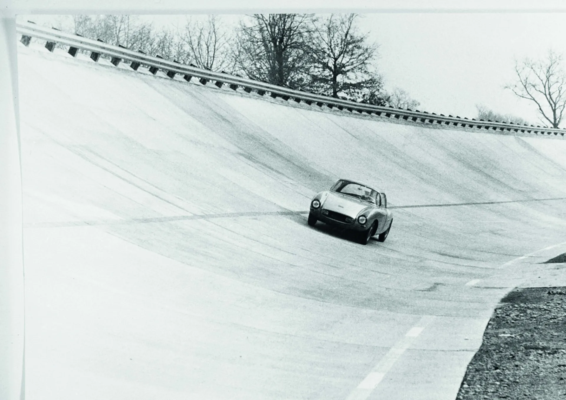 Historic race car driving on one of Monza’s legendary banked corners