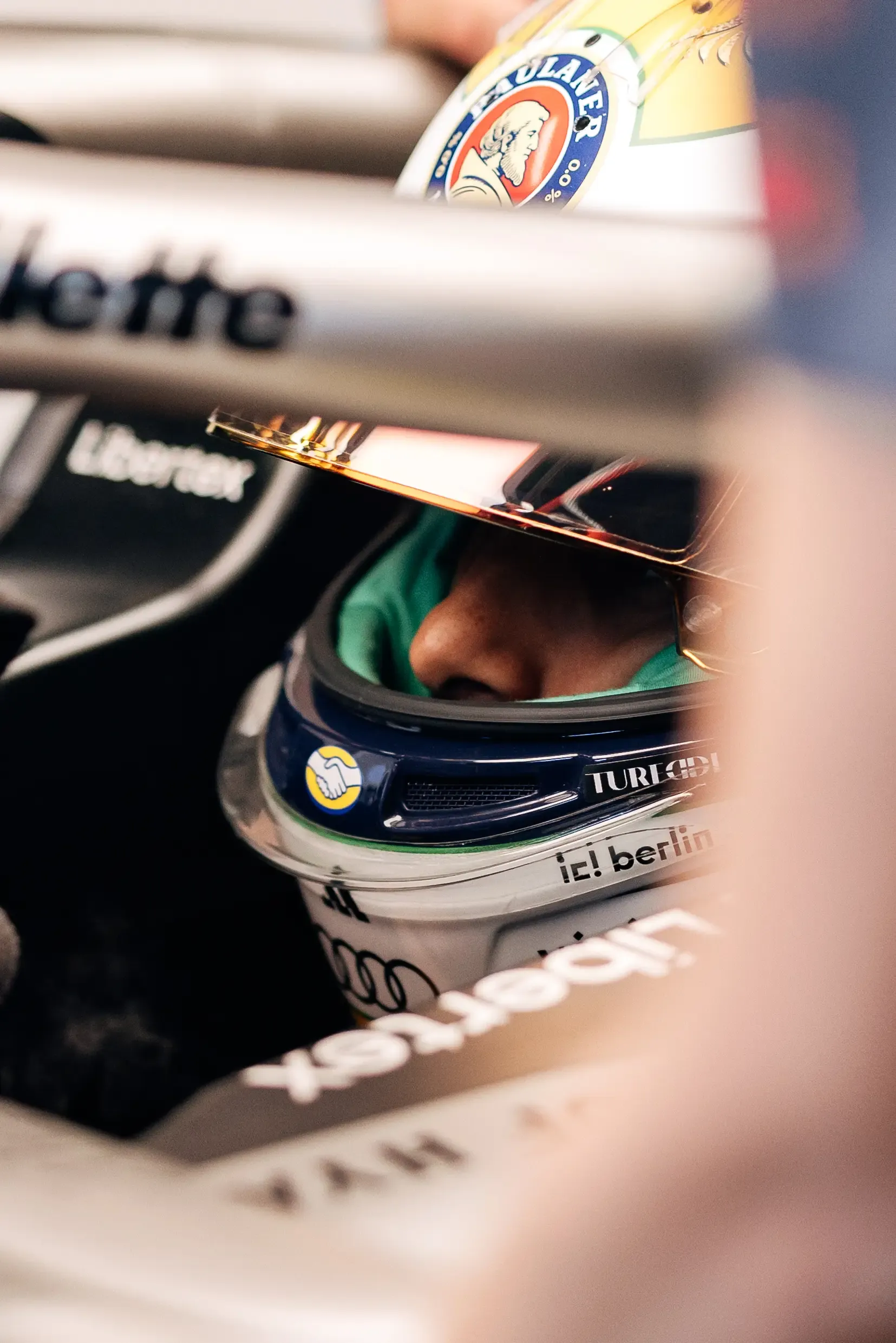 Close-up of an Audi Revolut F1® Team driver Gabriel Bortoleto in the cockpit, seen through the car.