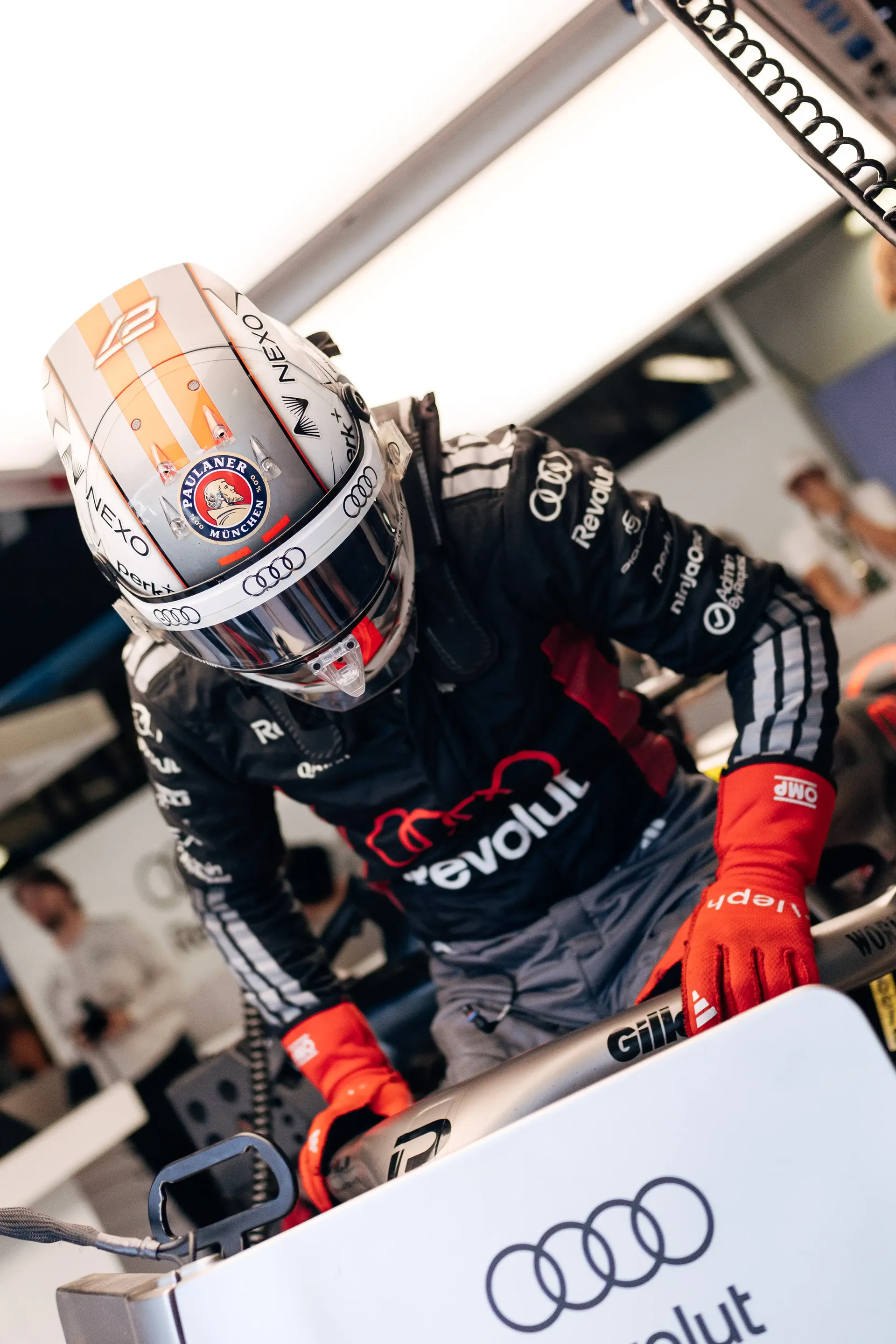 Audi Revolut F1® Team driver Nico Hulkenberg jumps into the cockpit of his Audi R26 team car inside the garage ahead of FP3