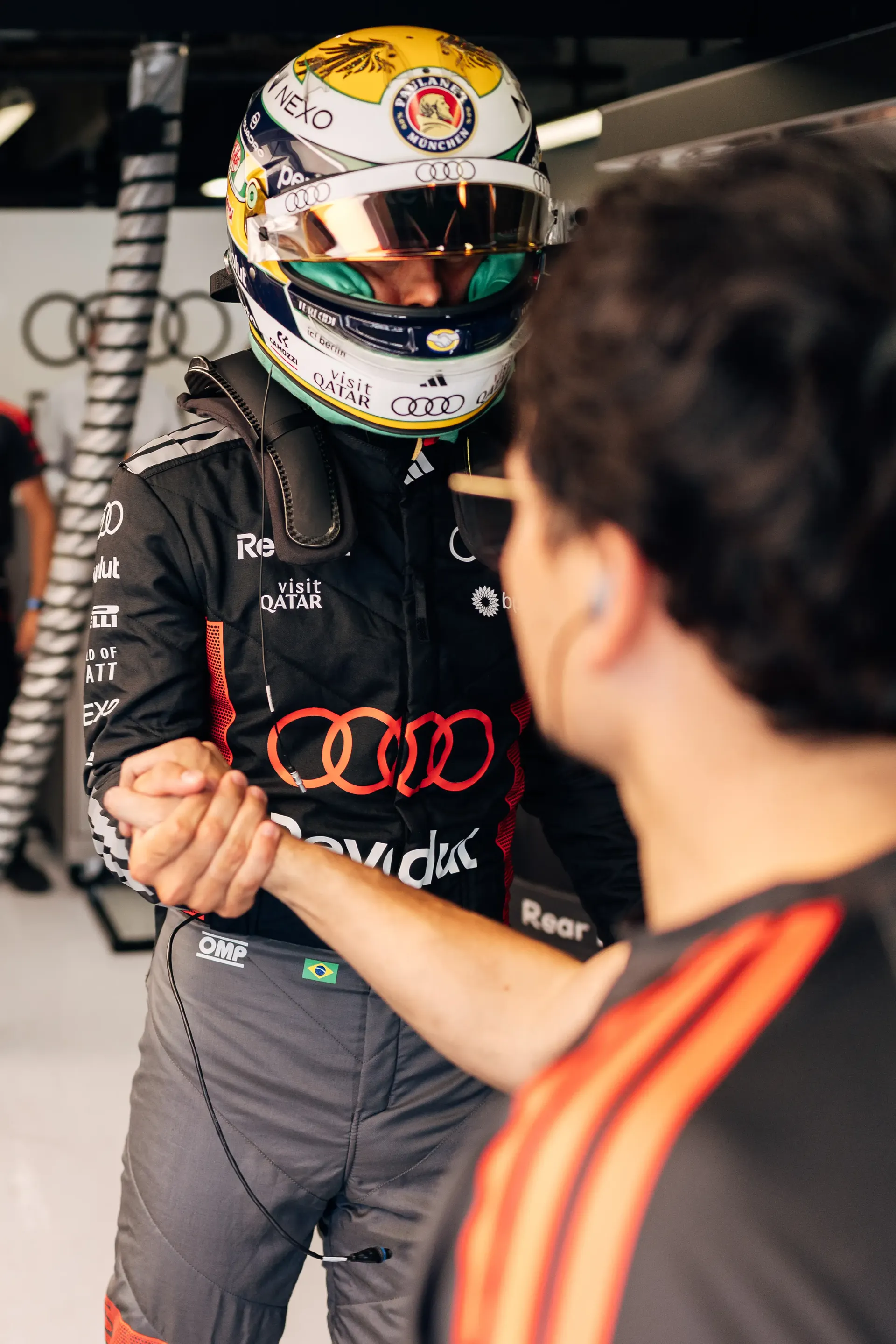 udi Revolut F1® Team driver Gabriel Bortoleto speaking with a team mechanic in the garage