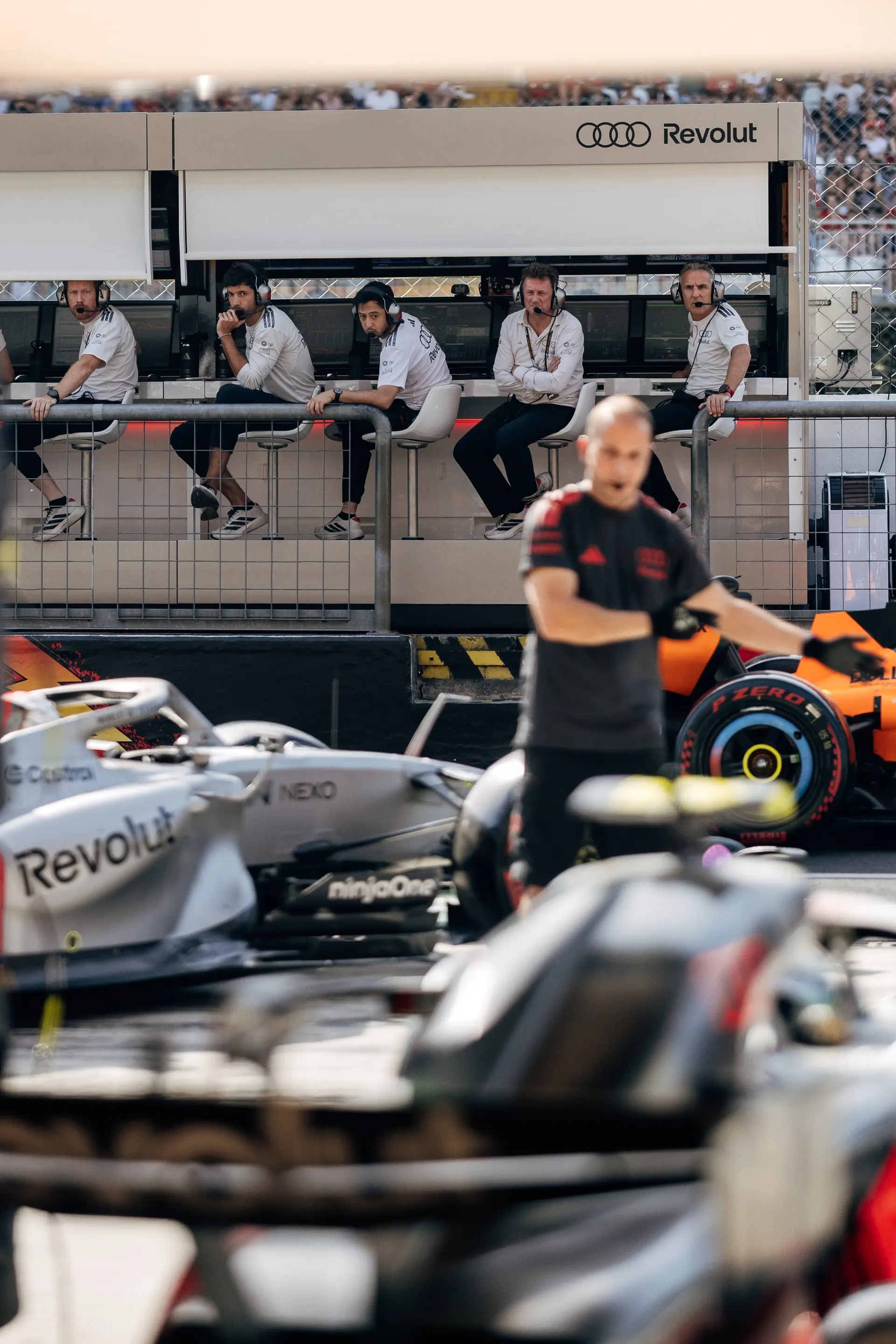 Audi Revolut F1® Team mechanics working around the car during pit preparation
