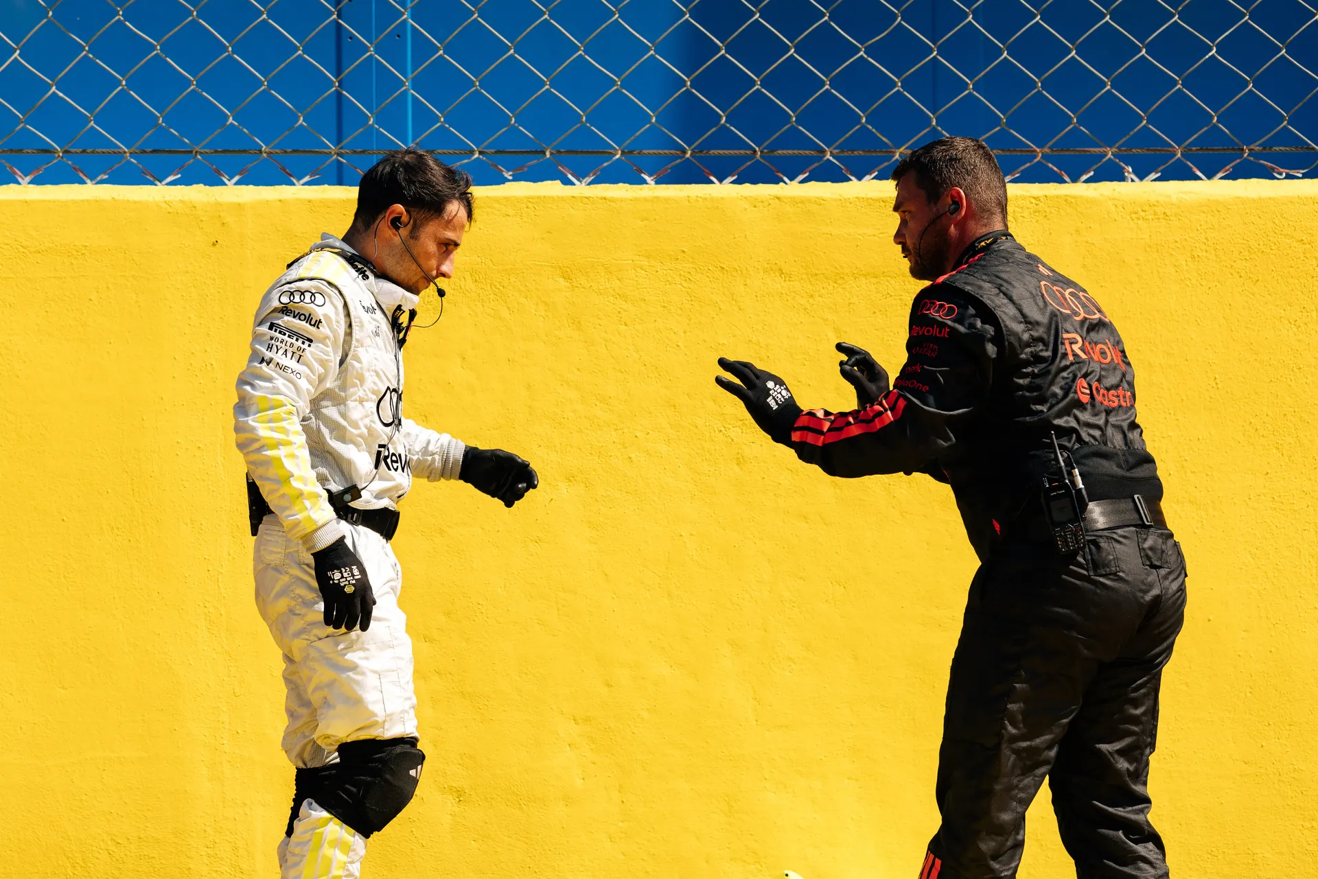 Audi Revolut F1® Team engineer talking with an Audi Revolut F1® Team mechanic beside the track at Monza