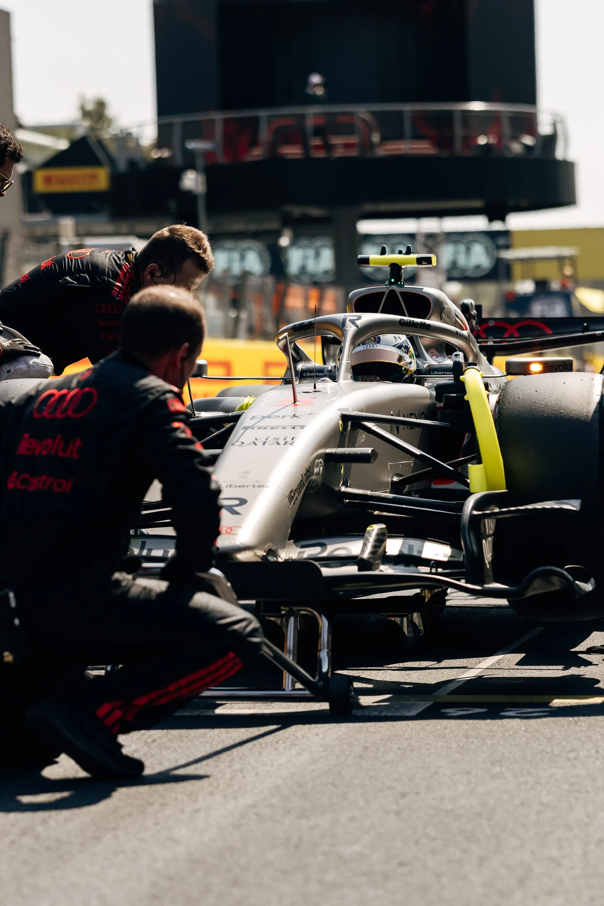 Audi R26 Formula 1® car in the pit lane with Audi Revolut F1® Team mechanics