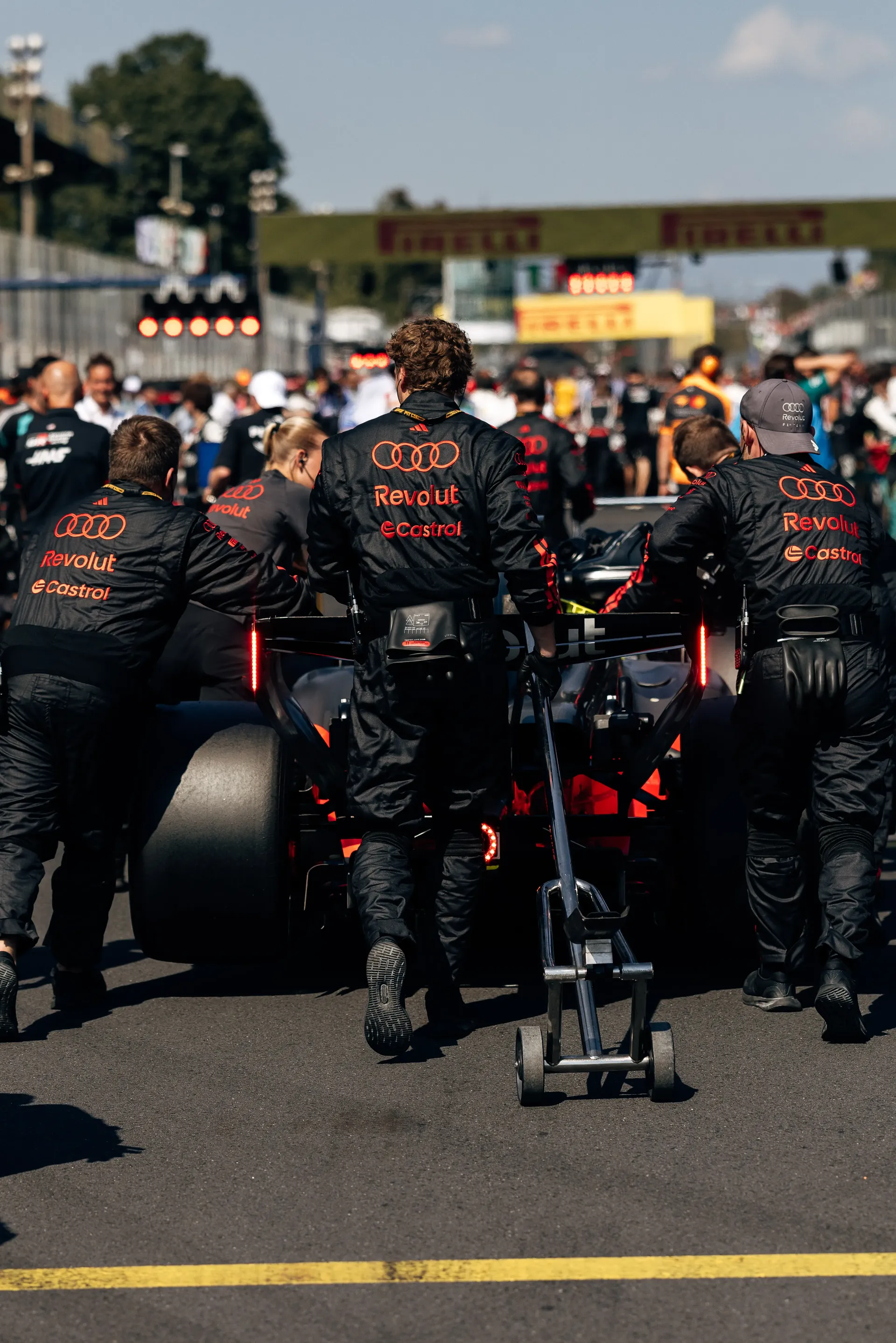 Audi Revolut F1® Team mechanics preparing the Audi R26 in the pit lane