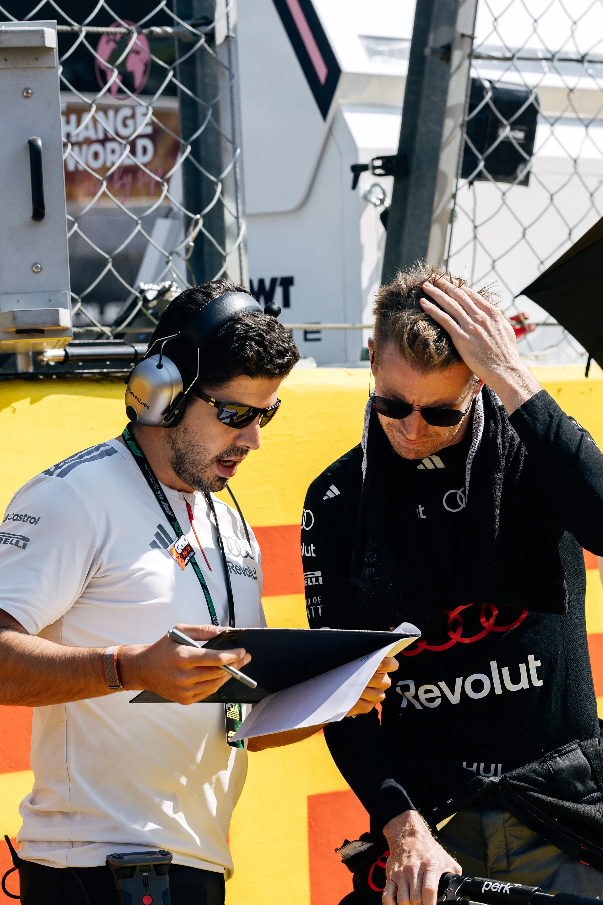 Audi Revolut F1® Team driver Nico Hulkenberg and engineer reviewing information in the Monza paddock