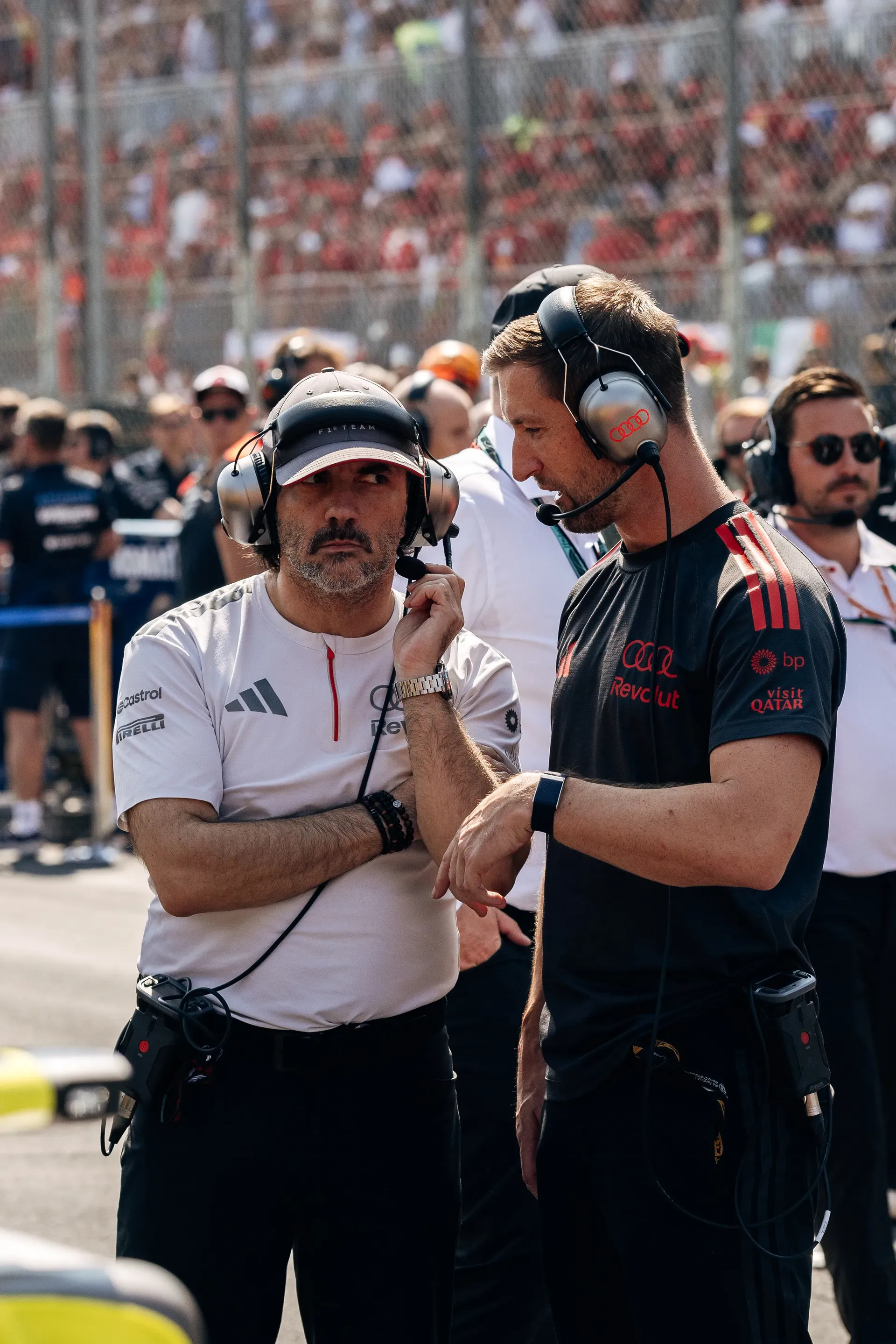 Audi Revolut F1® Team engineer talking with an Audi Revolut F1® Team team mechanic in the Monza paddock