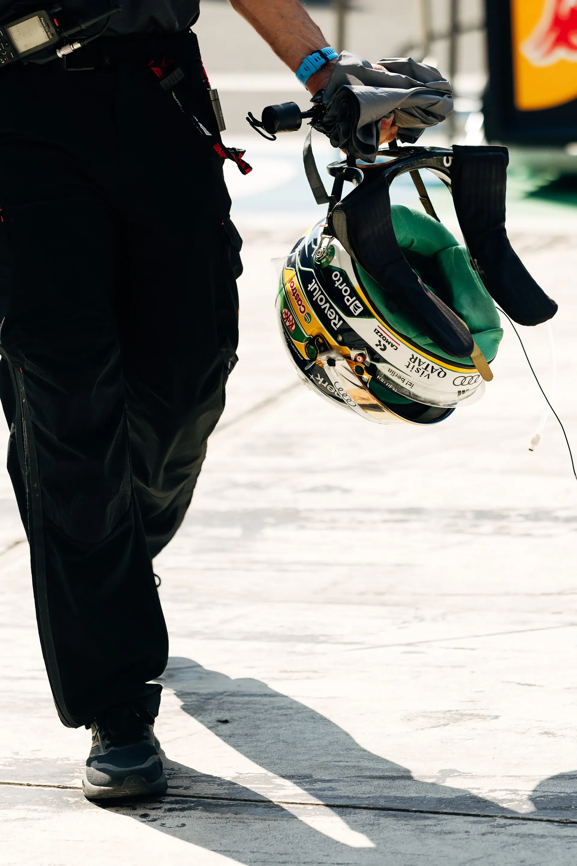 Audi Revolut F1® Team driver Gabriel Bortoletos green and yellow helmet being carried through the pit lane