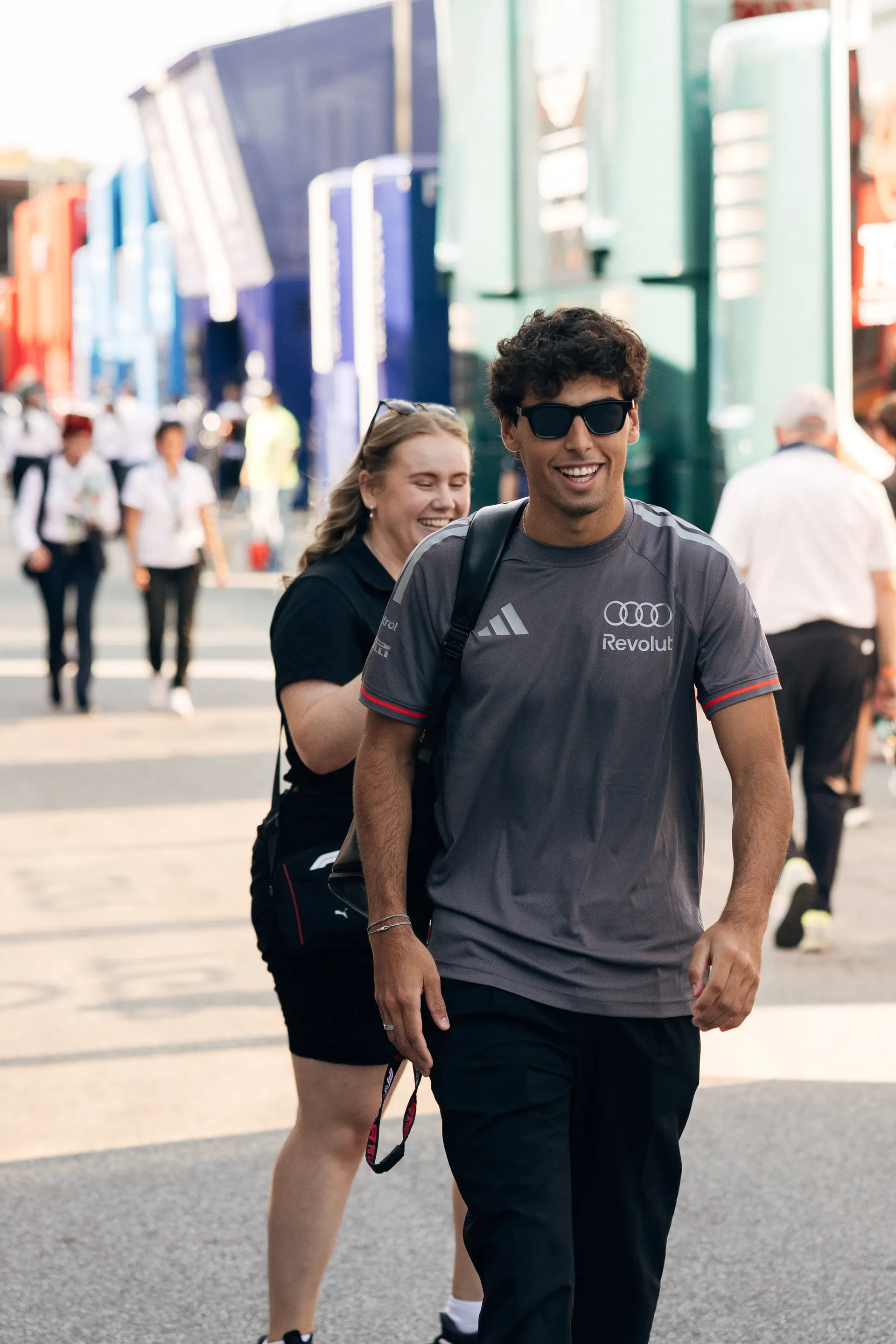 Audi Revolut F1® Team driver Gabriel Bortoleto walks through the paddock during Thursday arrivals ahead of the Italian Grand Prix.