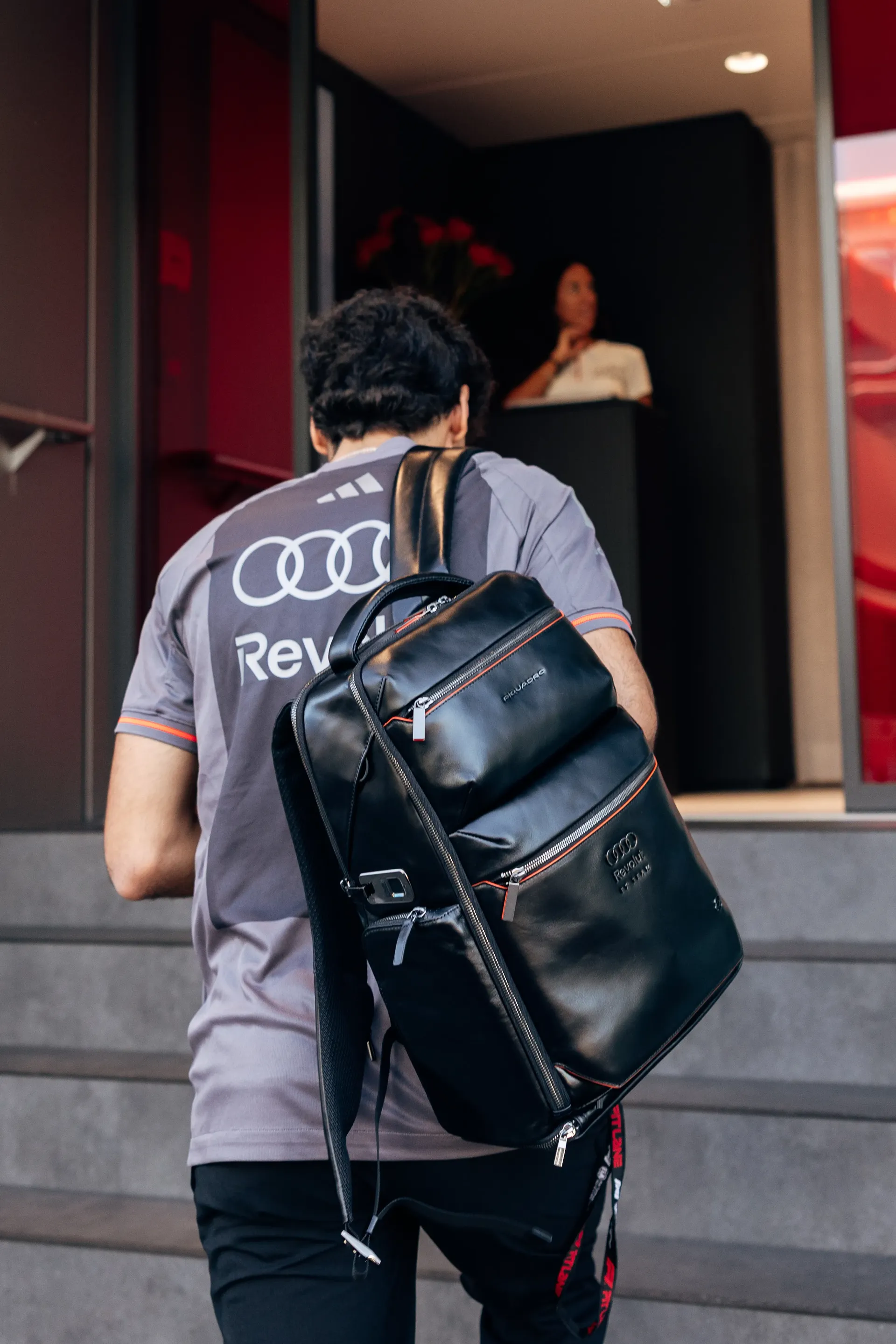 Rear view of Audi Revolut F1® Team driver Gabriel Bortoleto entering the paddock during Thursday arrivals at the Italian Grand Prix.