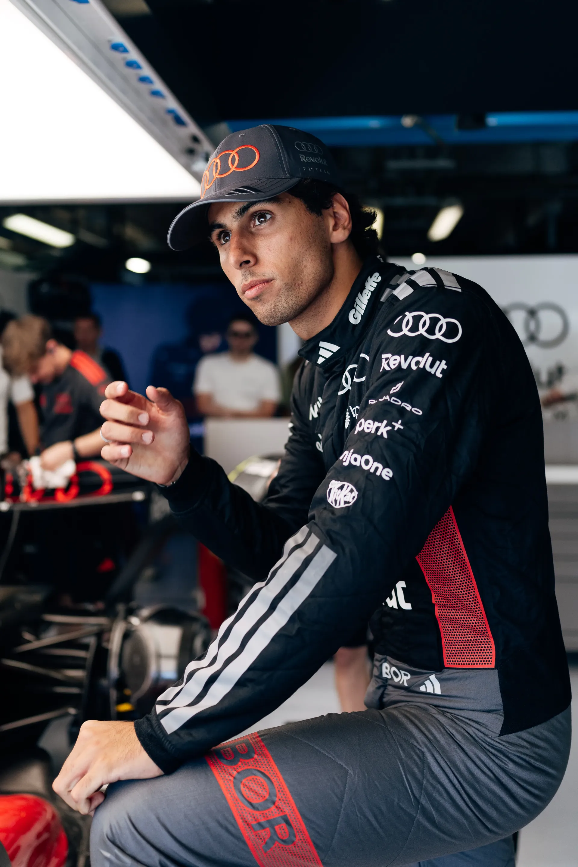 Gabriel Bortoleto working with Audi Revolut F1® Team mechanics inside the garage at the Italian Grand Prix.
