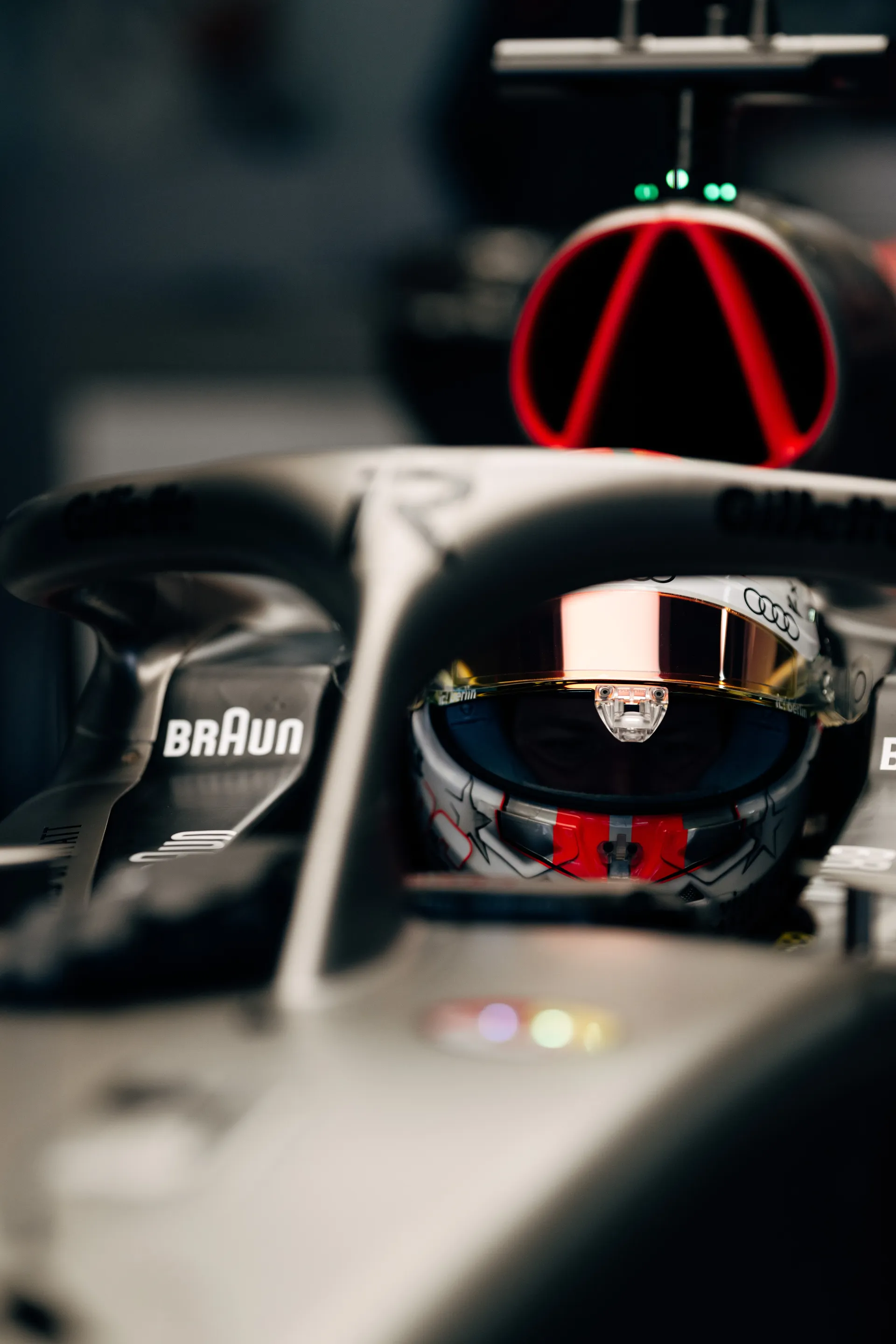 Close up of Nico Hulkenberg seated in the cockpit of the Audi Revolut F1® Team car, framed by the halo and front bodywork.