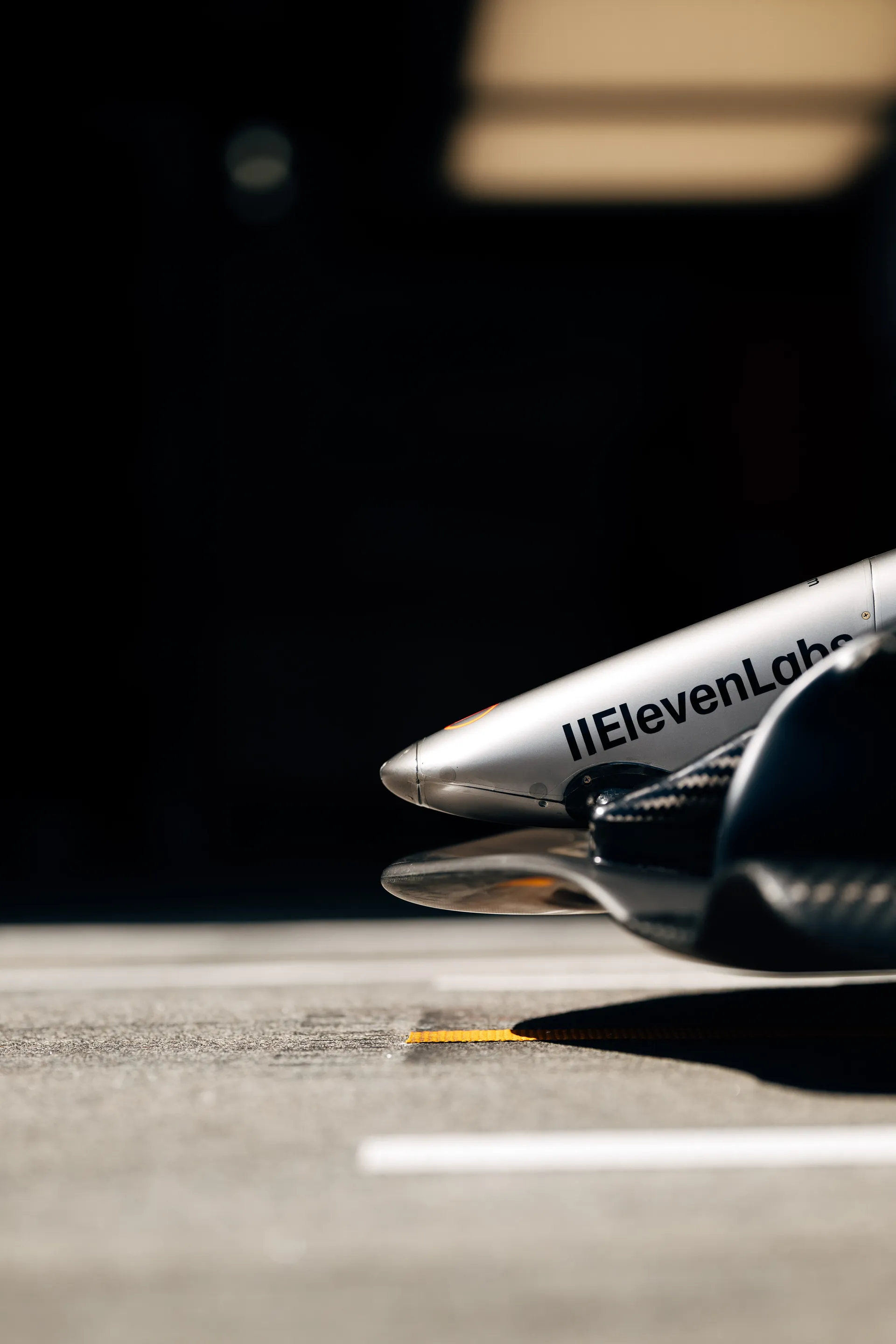 Low angle detail of the front wing endplate and nose area of the Audi Revolut F1® Team car, with ElevenLabs branding visible.