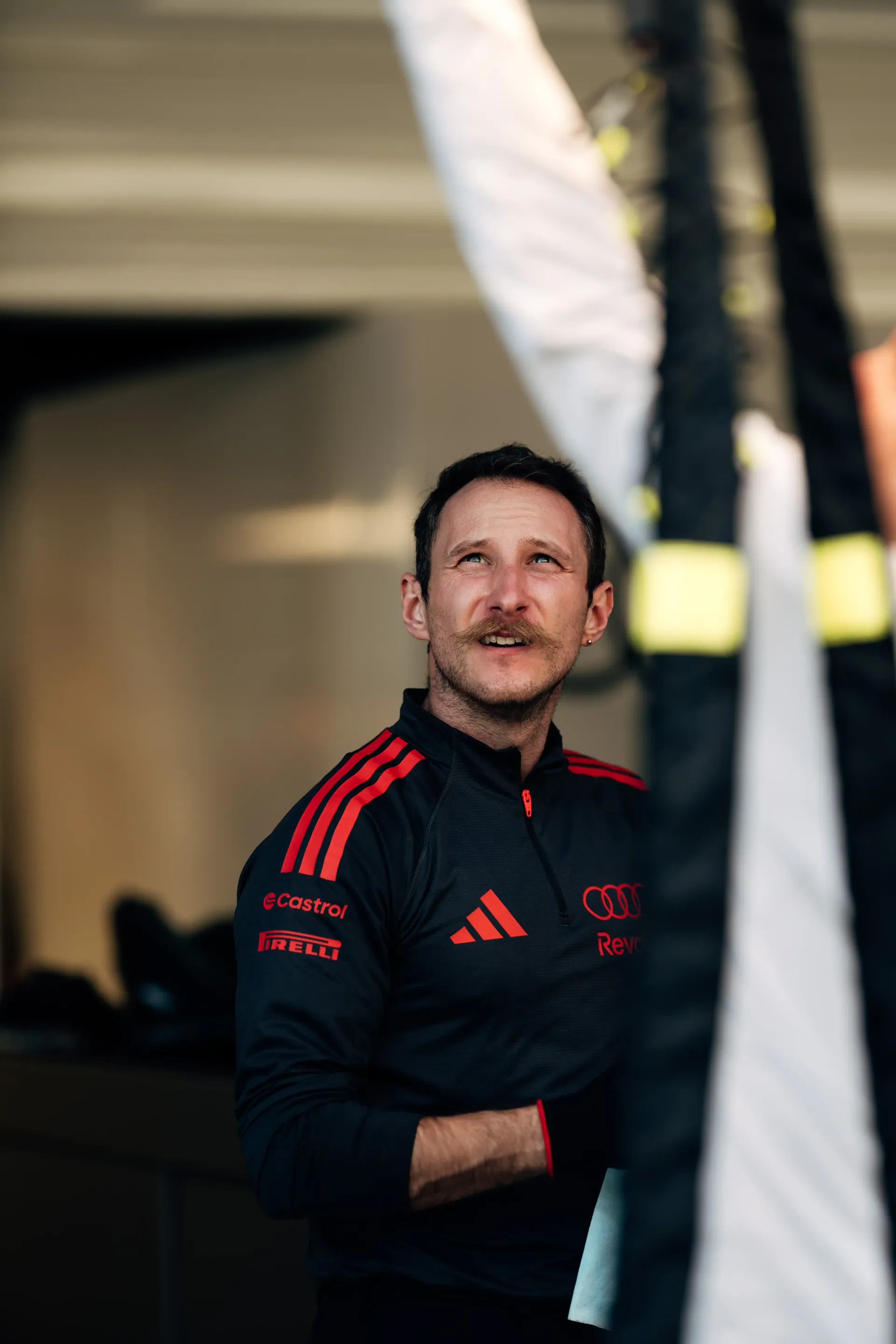 Portrait of Audi F1® engineer in the Suzuka garage, reflecting concentration and teamwork as the Audi Revolut F1® Team prepares for the Japanese Grand Prix F1®